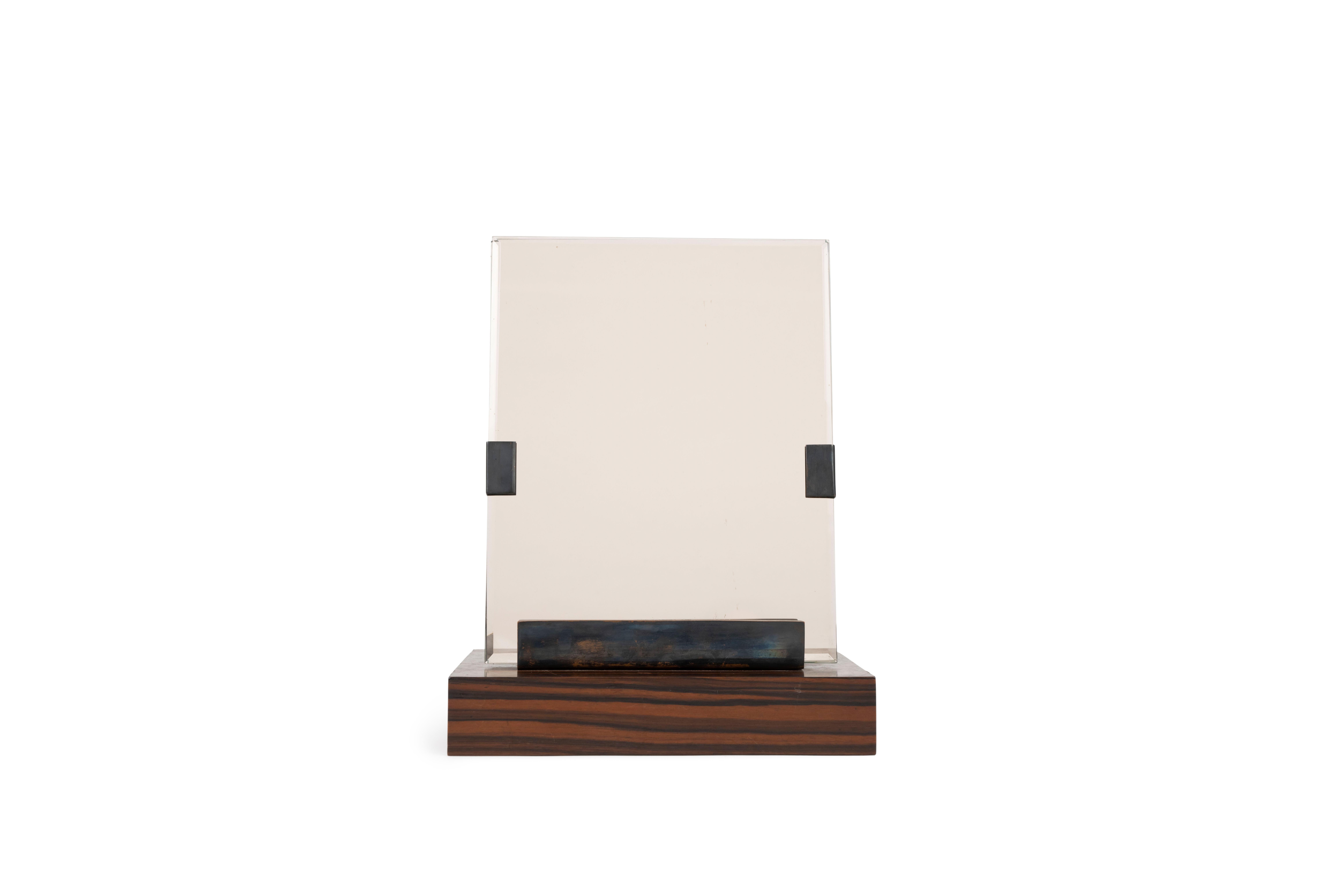 Photograph frame in Macassar ebony veneer and glass.


Émile-Jacques Ruhlmann (1879-1933) was a French furniture designer and interior decorator and one of the most important and influential figures of the Art Deco movement, even considered by some