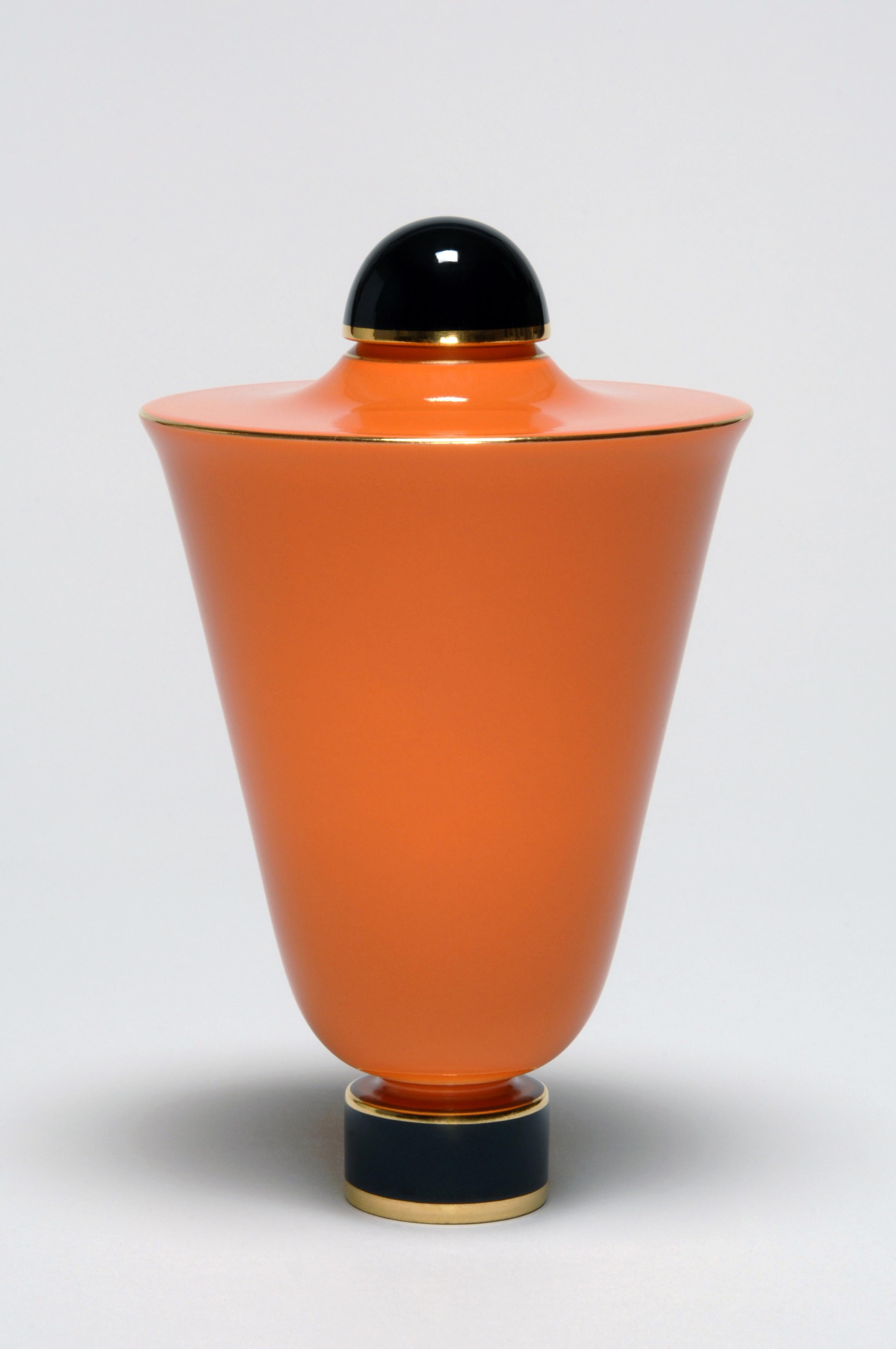 This vase was created in the 1920s by Émile-Jacques Ruhlmann for the Manufacture Royale de Sèvres. The cone-shaped body of the vase is mounted on a circular foot hand-painted. The deep orange of Sèvres color pigments / glaze is brought out by the