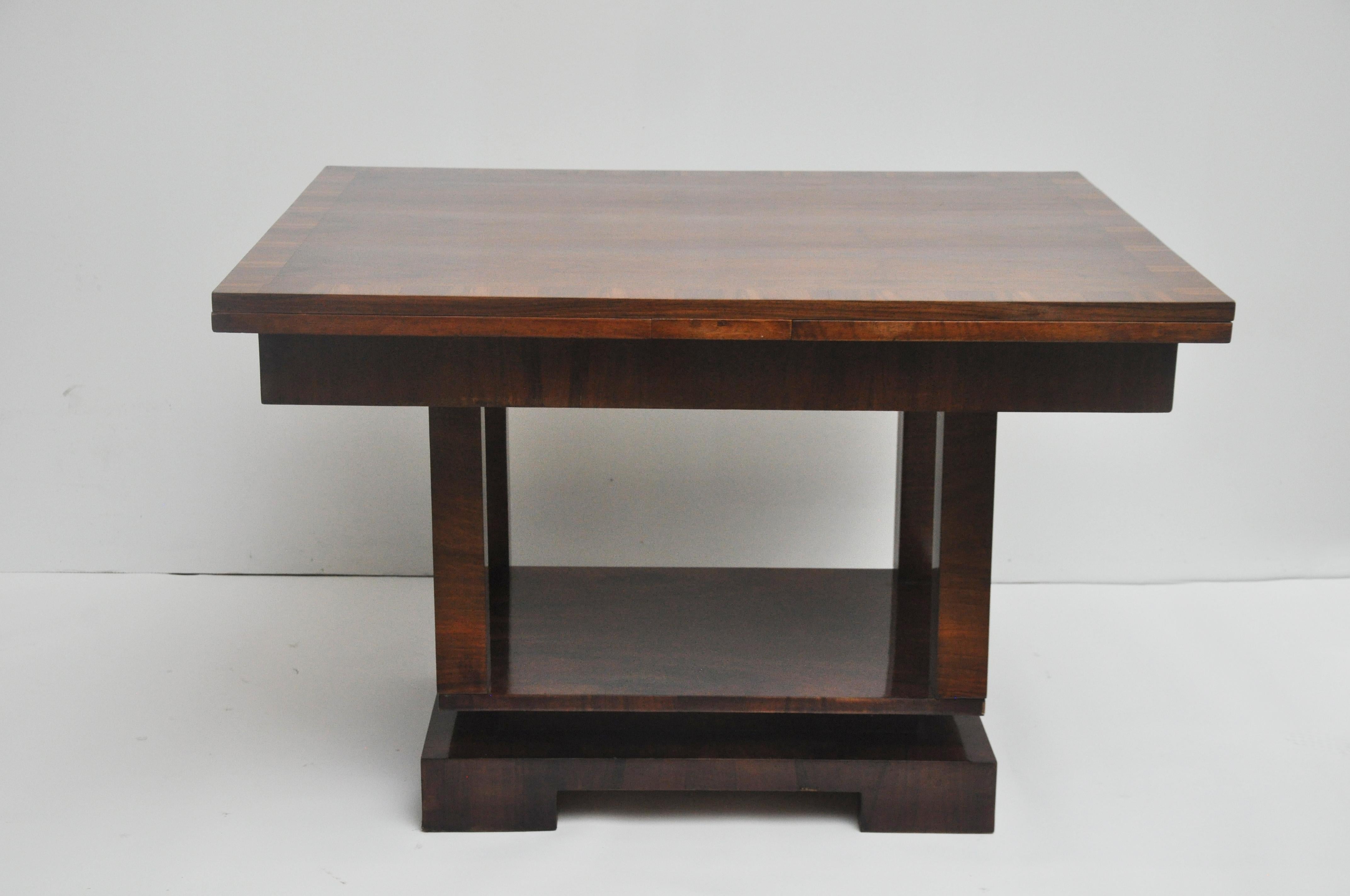 This Deco style extension table opens to 87.5