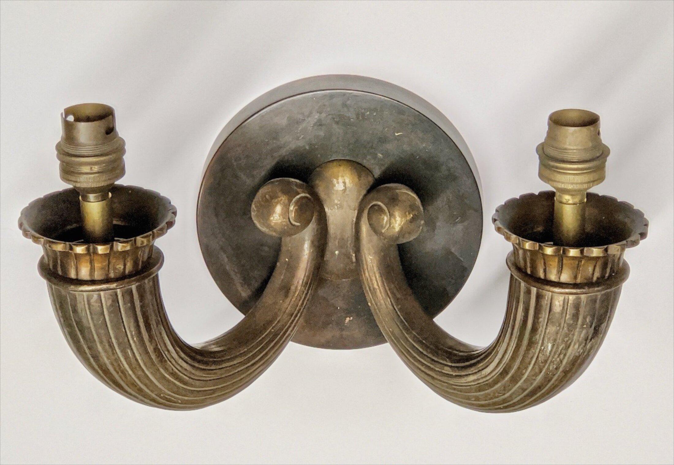 Classic French Art Deco two-branch sconce in sculpted bronze, circa 1925. In the style of Ruhlmann. Measures: 12” wide x 7” deep x 7” high.