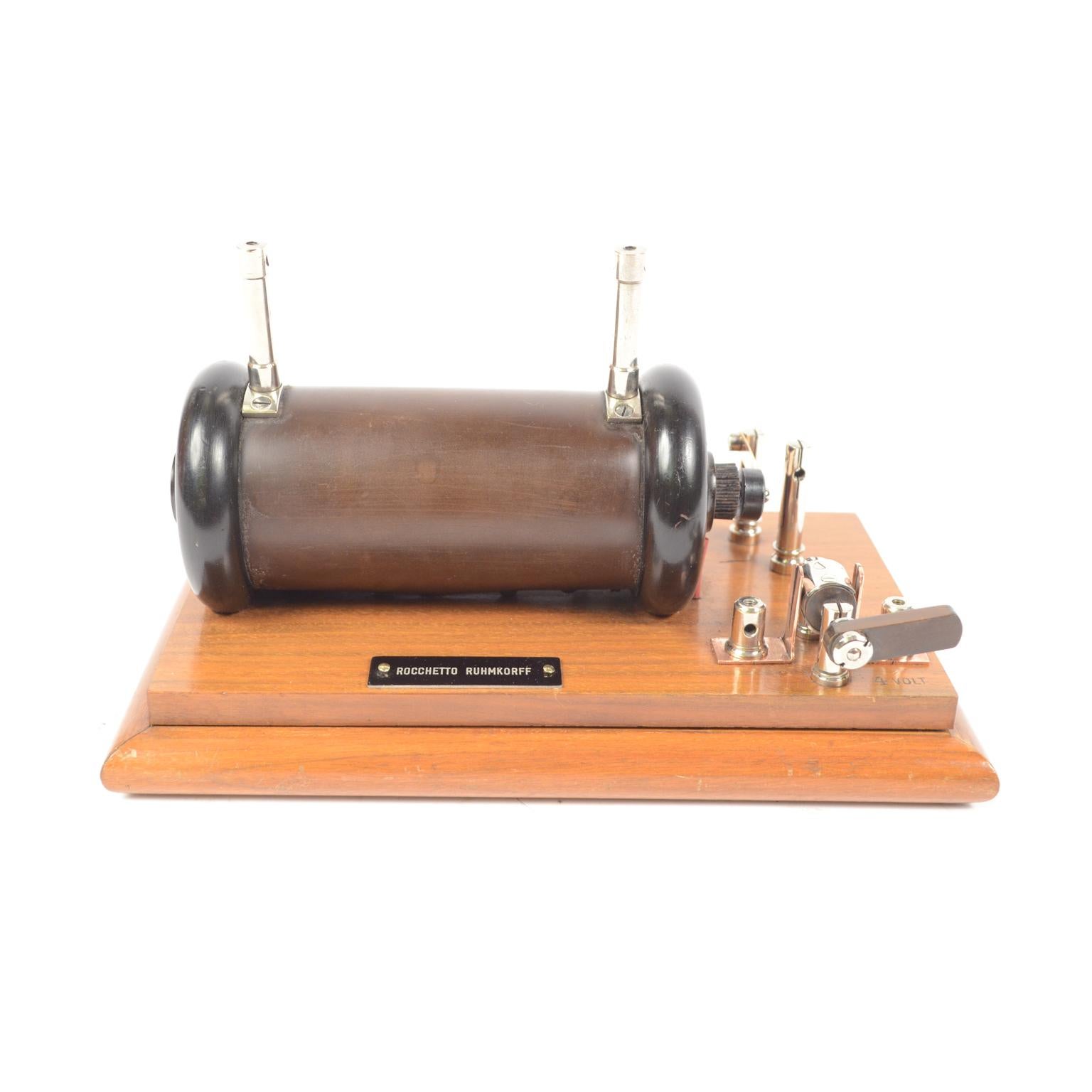 Antique nduction spool also called Ruhmkorff spool conceived circa mid-19th century, an instrument used to produce high voltage electric discharges starting from a low voltage direct current. Mounted on a walnut board. The induction spools were used