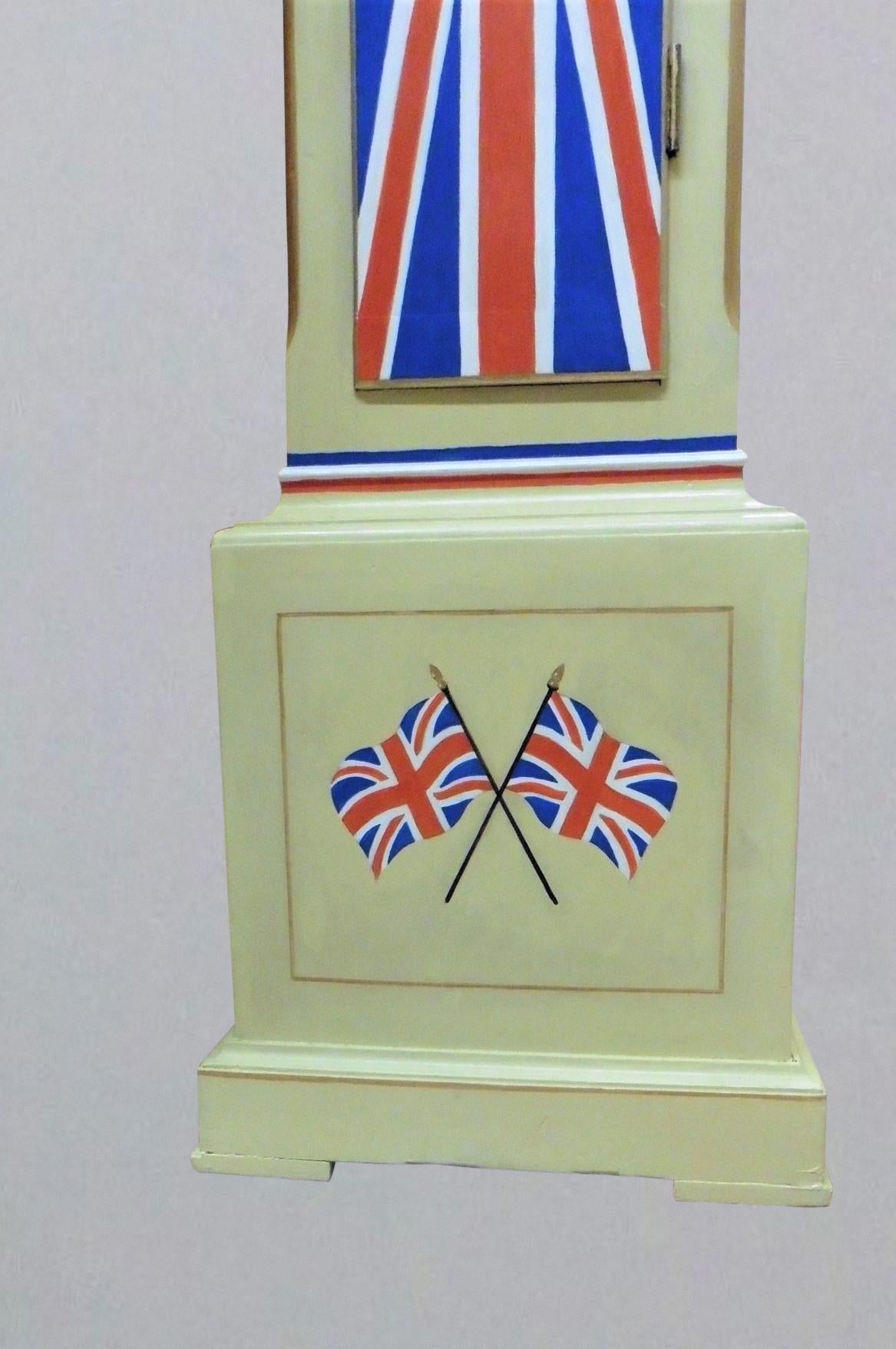 Rule Britannia Grandmother clock c,1930

Grandmother clock standing on a raised, moulded plinth resting on four pad feet. Decorated on a cream ground with the Union Jack to the trunk door with gilded canted corners. Twin Union Jack flags to the