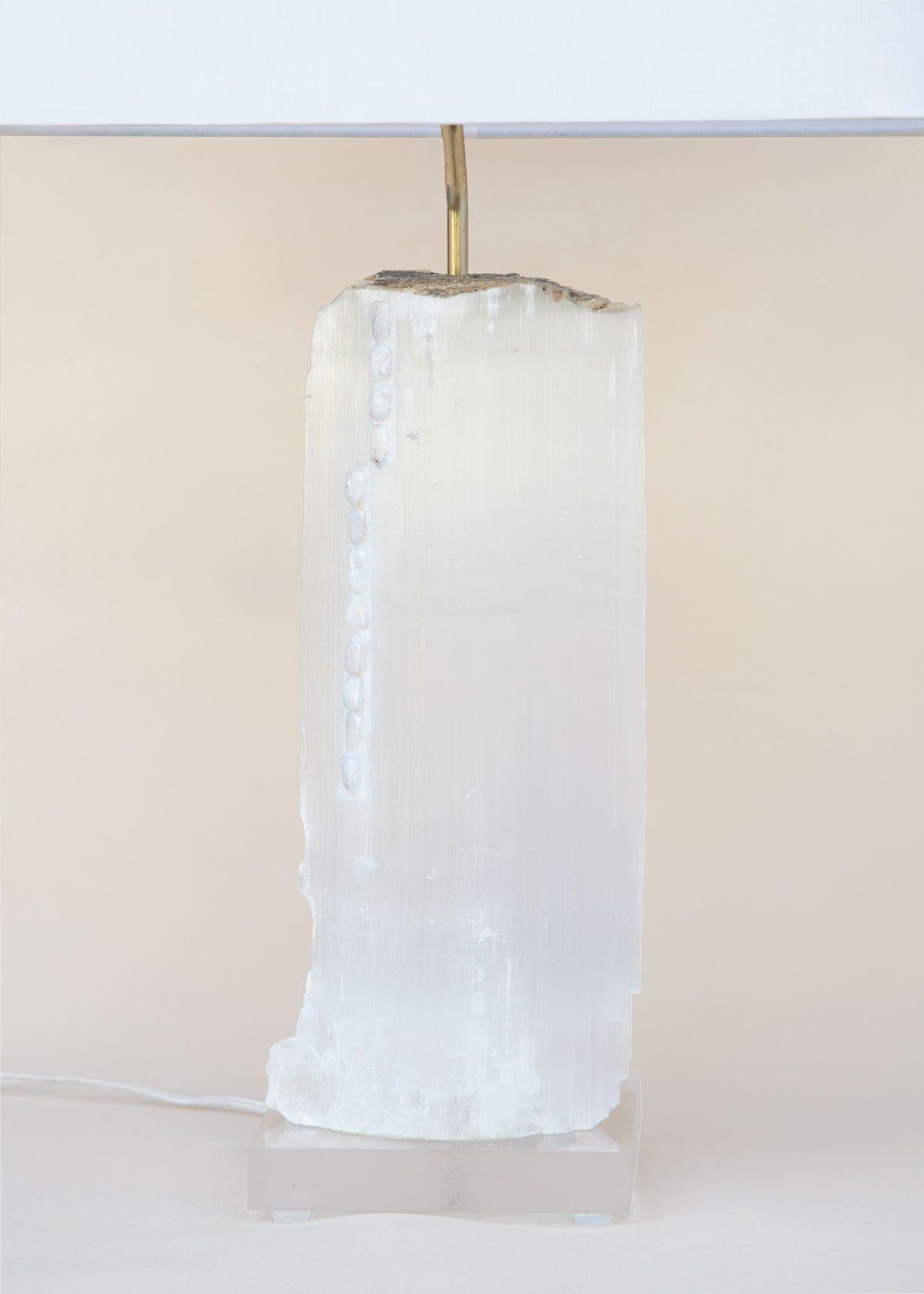 A ruler selenite lamp with baroque pearls on lucite. 

Ruler selenite is made up of single prismatic crystals from Morocco that were formed in extensive beds by the evaporation of ocean brine. This mineral is characterized by a silk, pearly luster