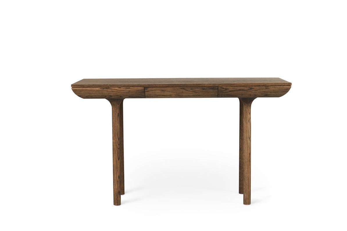 Rúna Smoked Oak Desk by Warm Nordic
Dimensions: D130 x W65 x H74 cm
Material: Smoked solid oak
Weight: 37 kg
Also available in different finishes. Please contact us.

Timeless desk with a poetic idiom and a neat little drawer. With its pure