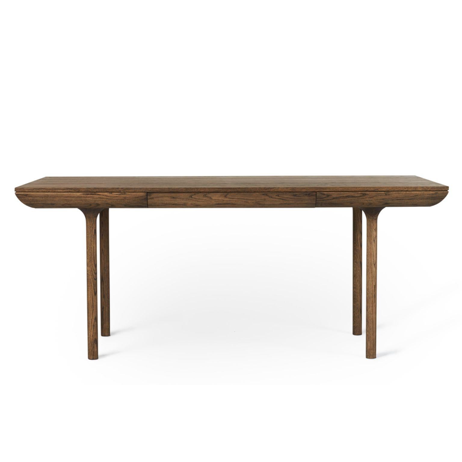 Rúna Smoked Oak Dining Table by Warm Nordic
Dimensions: D180 x W90 x H74 cm
Material: Smoked solid oak
Weight: 47 kg
Also available in different finishes. Please contact us.

Timeless dining table with a poetic idiom and a neat little drawer. With