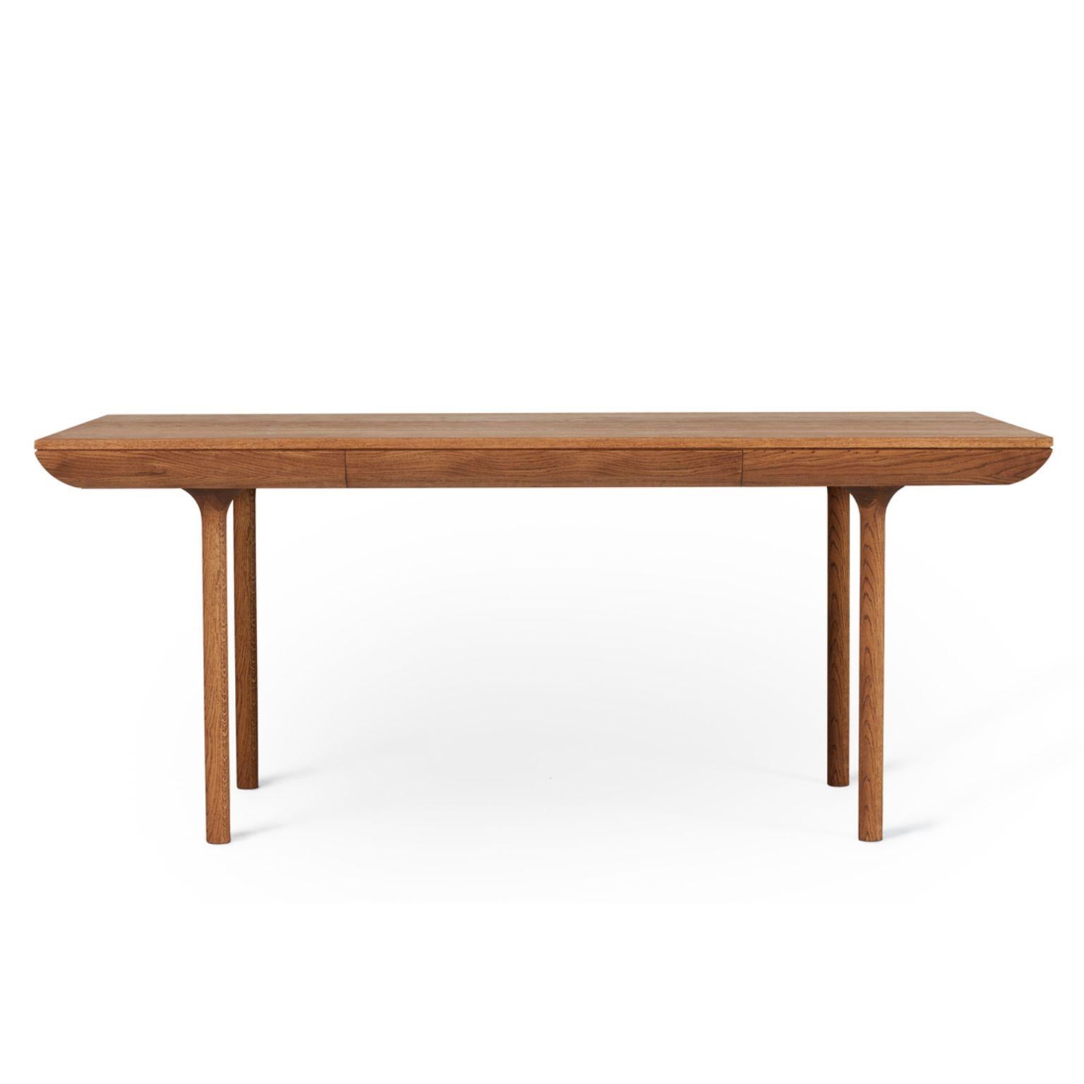 Rúna teak oiled oak dining table by Warm Nordic
Dimensions: D 180 x W 90 x H 74 cm
Material: Teak oiled solid oak
Weight: 47 kg
Also available in different finishes.

Timeless dining table with a poetic idiom and a neat little drawer. With its