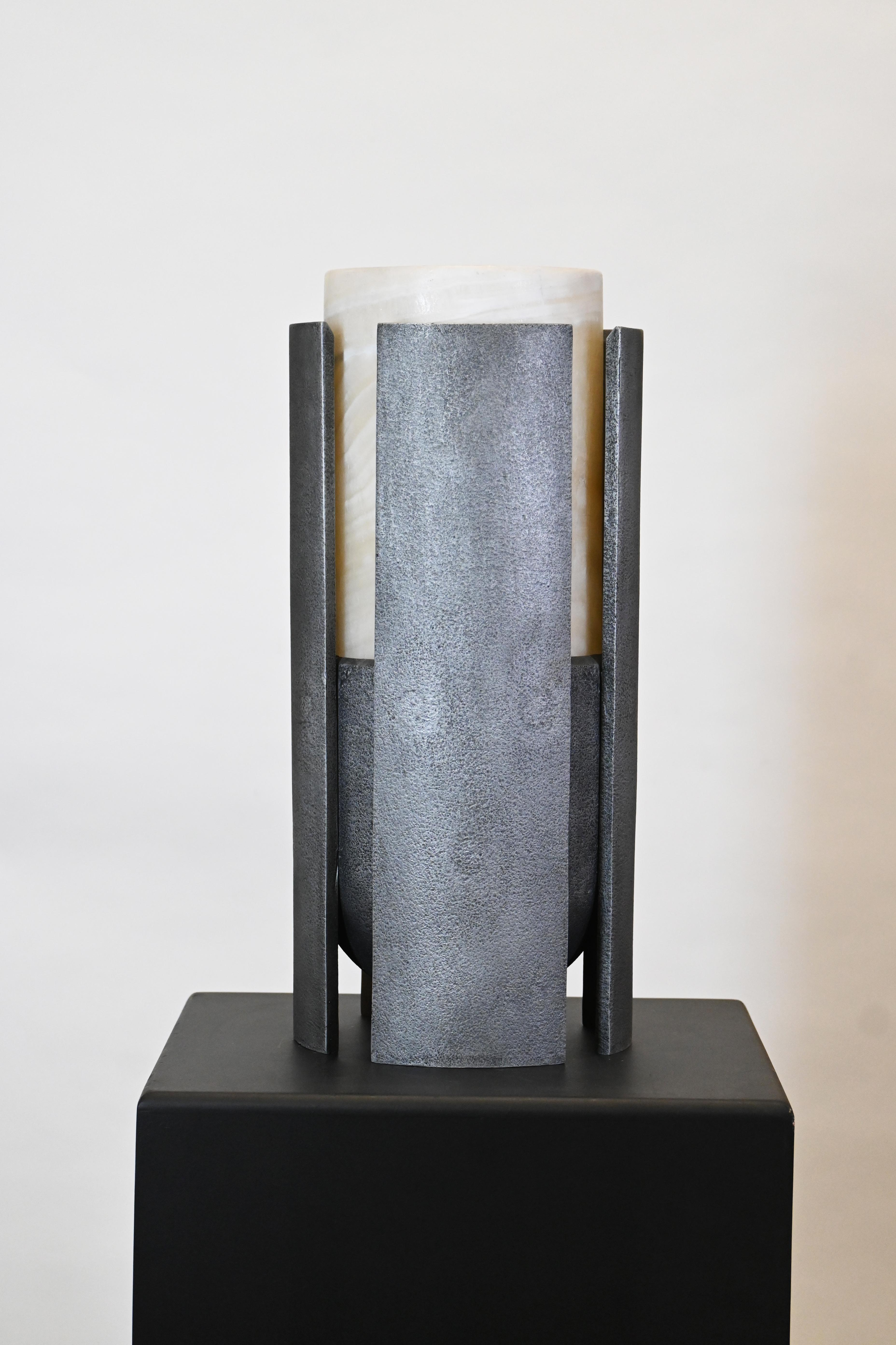 Runa Series-Graphite and Obsidian  Sculptural Vase 
By Deceres Studio
San Luis onyx and casted graphite aluminum
Obsidian and casted black aluminum
Edition of 7 
22D x 50H cm 
8.6D x 19.6H in

Runa is a sculptural vase inspired by ceremonial rituals