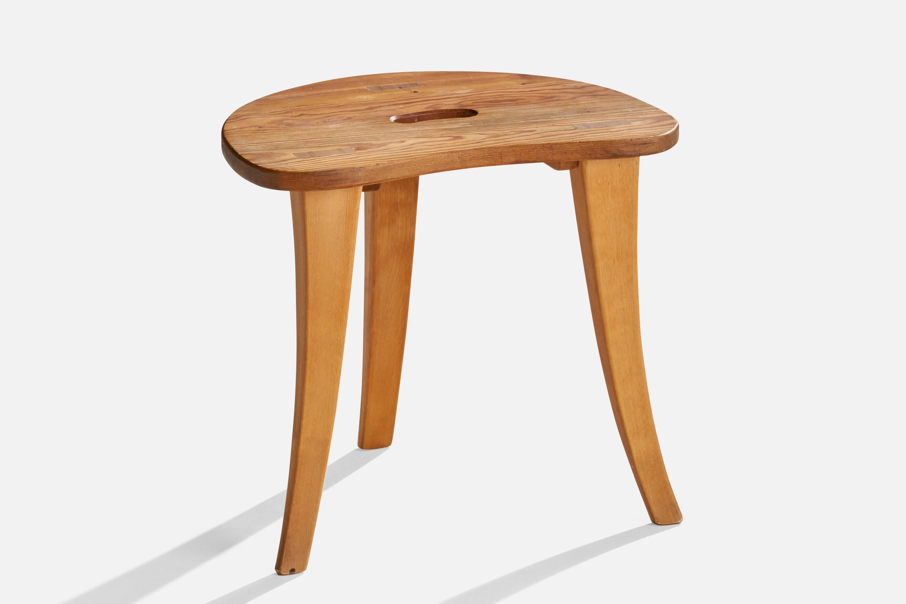 A pine stool designed and produced by Rune Larsson, Ambjörby, Sweden, dated 1999.
