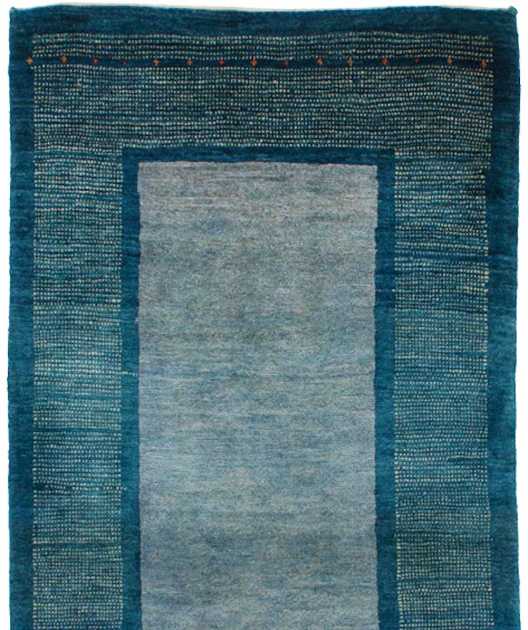 Runner, cornflower blue contemporary tribal border Gabbeh Persian wool rug. A tranquil runner featuring watery blues, this includes a center stripe with just a hint of lavender. Think French blue, the hills of Provence, and cornflowers for an idea