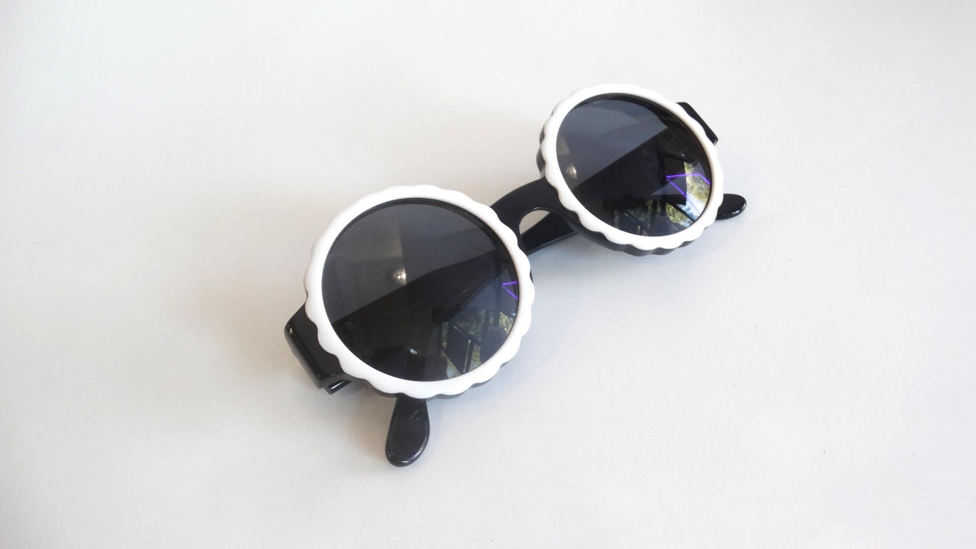 Your New Go To Sunglasses! Circa Spring 1994 Runway, these Chanel circle sunglasses feature a white scalloped trim around the lenses. The signature CC is featured on the side of both arms. Perfect for every vacation and day trip! Signed Chanel Made