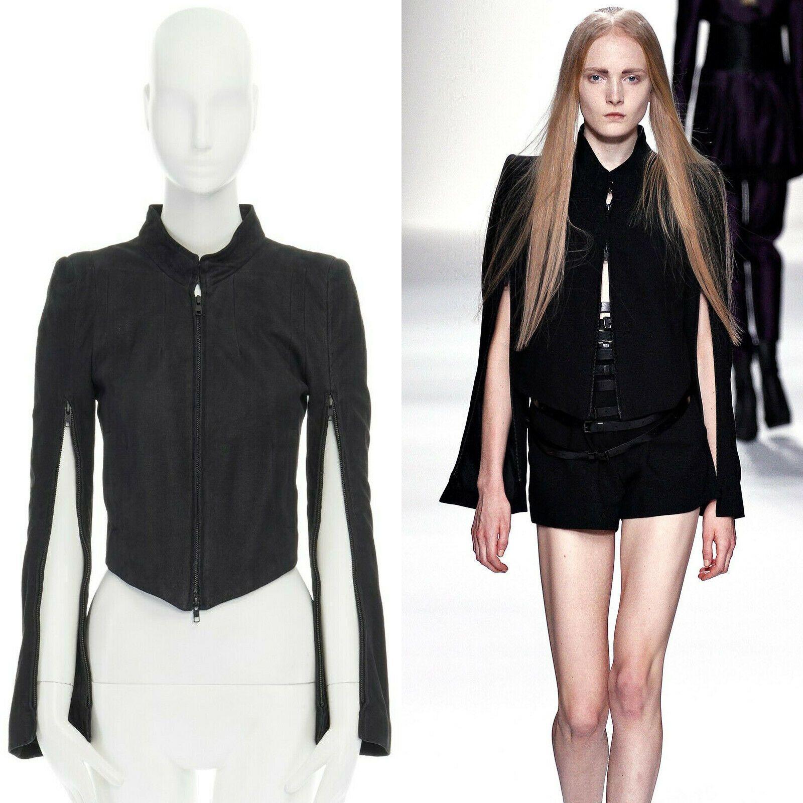 runway ANN DEMEULEMEESTER black leather convertible zip sleeves crop jacket XS
ANN DEMEULEMEESTER
100% leather. Stand collar. Dual hook eye closure at neck. 
Zip front closure. Padded shoulder. Long sleeves. 
Zipped trimmed along sleeves. Cropped