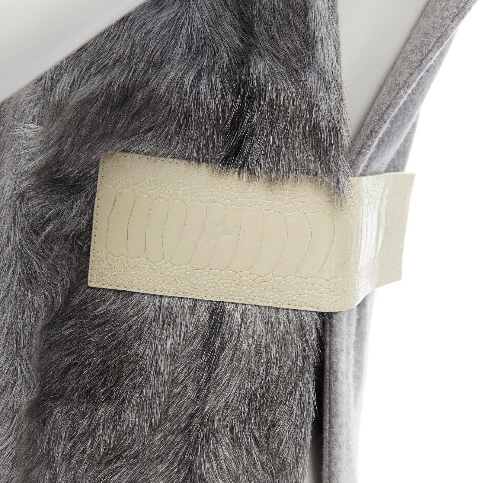 runway CELINE grey goat fur 100% cashmere leather belt tab turtleneck vest top S
CELINE BY PHOEBE PHILO
FROM THE 2013 COLLECTION
100% cashmere. 
Genuine goat fur paneled front. 
High turtleneck collar. 
Cream stamped leather belt detail. 
Open side.