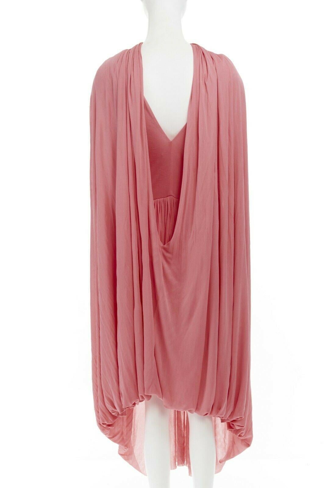 runway CELINE PHOEBE PHILO pink fluid viscose draped cape midi dress FR36 S
CELINE BY PHOEBE PHILO
Fluid cape dress. 
Pink viscose. V-neck. 
Sleeveless. Pleated skirt. 
Attached cape detail at skirt to be worn around neck. 
Concealed zip closure.