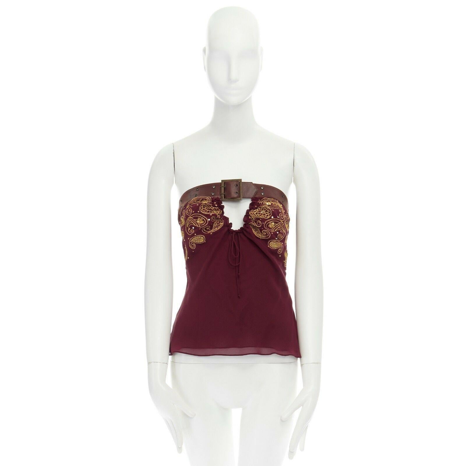 runway CHRISTIAN DIOR GALLIANO AW02 belted embroidered silk top FR38 US6

CHRISTIAN DIOR BY JOHN GALLIANO
FROM THE FALL WINTER 2002 RUNWAY AND CAMPAIGN
SILK, LAMBSKIN LEATHER . BROWN GROMMET STUDDED BELT DETAIL ON BUST . 
ADJUSTABLE DUAL PRONG