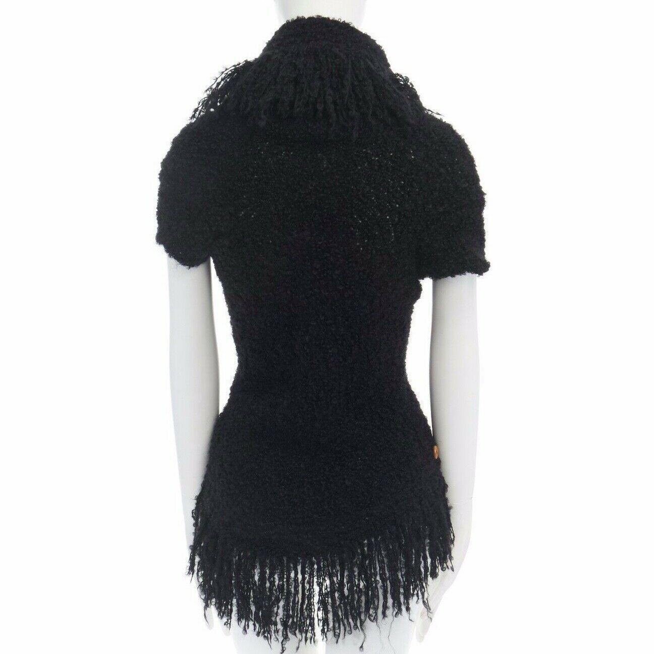 runway COMME DES GARCONS AW02 black mohair fringe trimmed circle cut cardigan

COMME DES GARCONS
FROM THE FALL WINTER 2002 COLLECTION
Mohair, wool, nylon. Knitted. Fringe trimmed. Button front closure. 
Long sleeve. It becomes a circle when laid