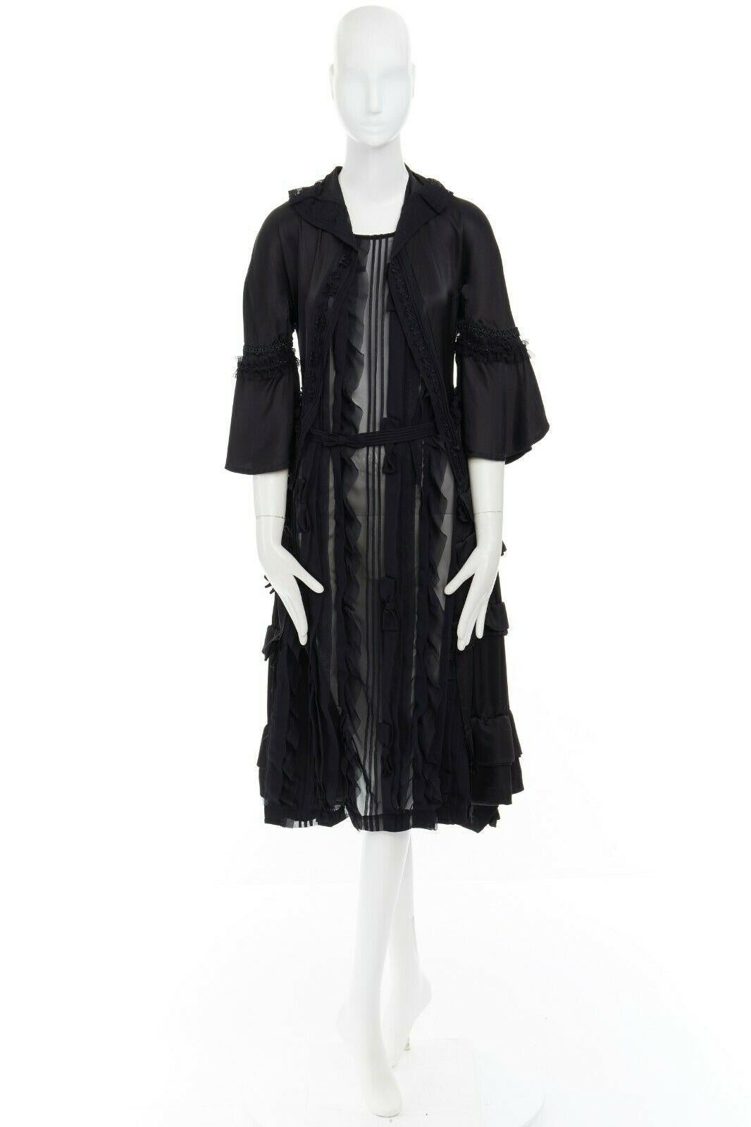 COMME DES GARCONS
From the Fall Winter 'BROKEN BRIDE' 
Collection Silk, polyester • Black • Victorian inspired dress • An illusion of a jacket over dress • Spread collar • 3/4 wide flared victorian sleeves • Grommet and lace trimming on sleeve •