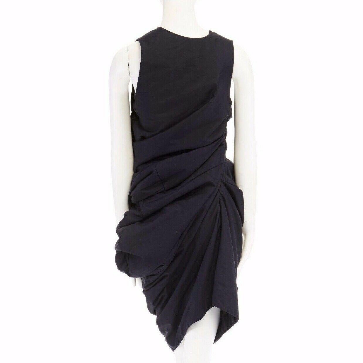 runway COMME DES GARCONS SS1997 Lumps Bumps black circle cut asymmetric dress S

COMME DES GARCONS
FROM THE SPRING SUMMER 1997 LUMPS AND BUMPS RUNWAY
Black . Scooped neckline . Open slit under left arm . Safety pinned closure . 
Sleeveless . Circle