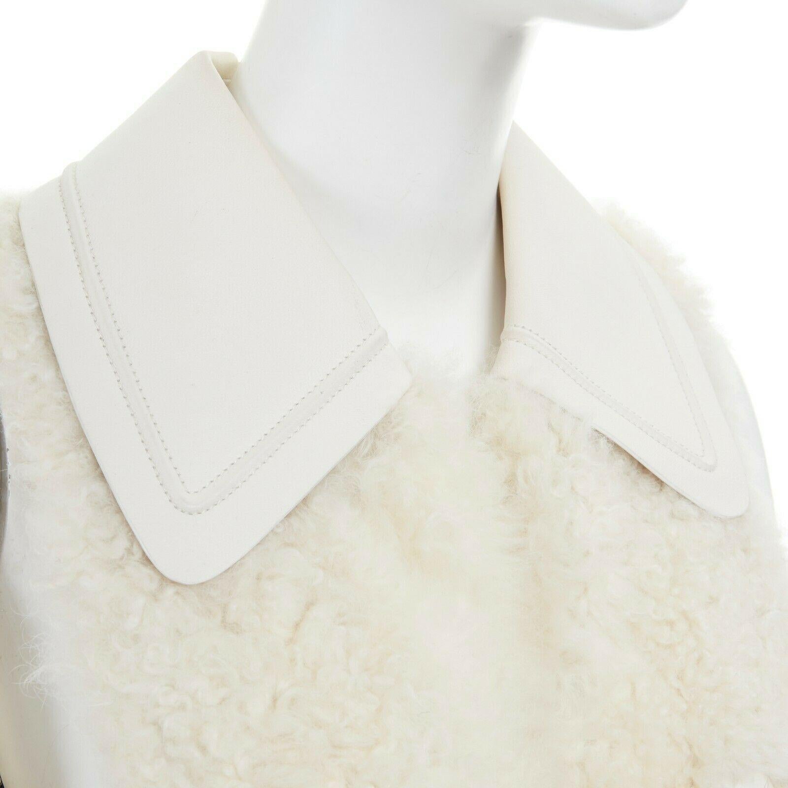 runway FENDI shearling fur white leather collar patch pocket vest jacket IT40 S
FENDI
FROM THE FALL WINTER 2015 COLLECTION
Genuine shearling fur outer. 
White leather collar and pocket. 
Wide spread collar. 
Ivory large resin button and toggle