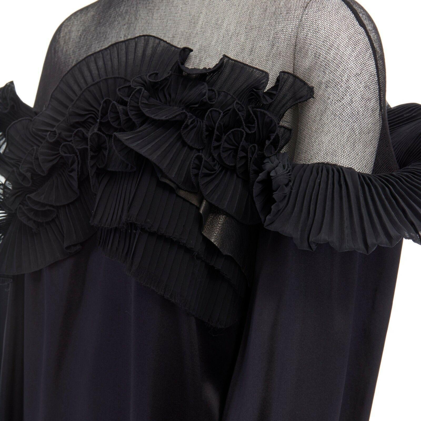 runway GIVENCHY TISCI AW08 black pleated ruffle lace sheer yoke silk top FR36

GIVENCHY BY RICCARDO TISCI
FROM THE FALL WINTER 2008 RUNWAY100% silk. Black. 
Pleated ruffle volume, lace and leather panel trimming across chest. 
Sheer knitted