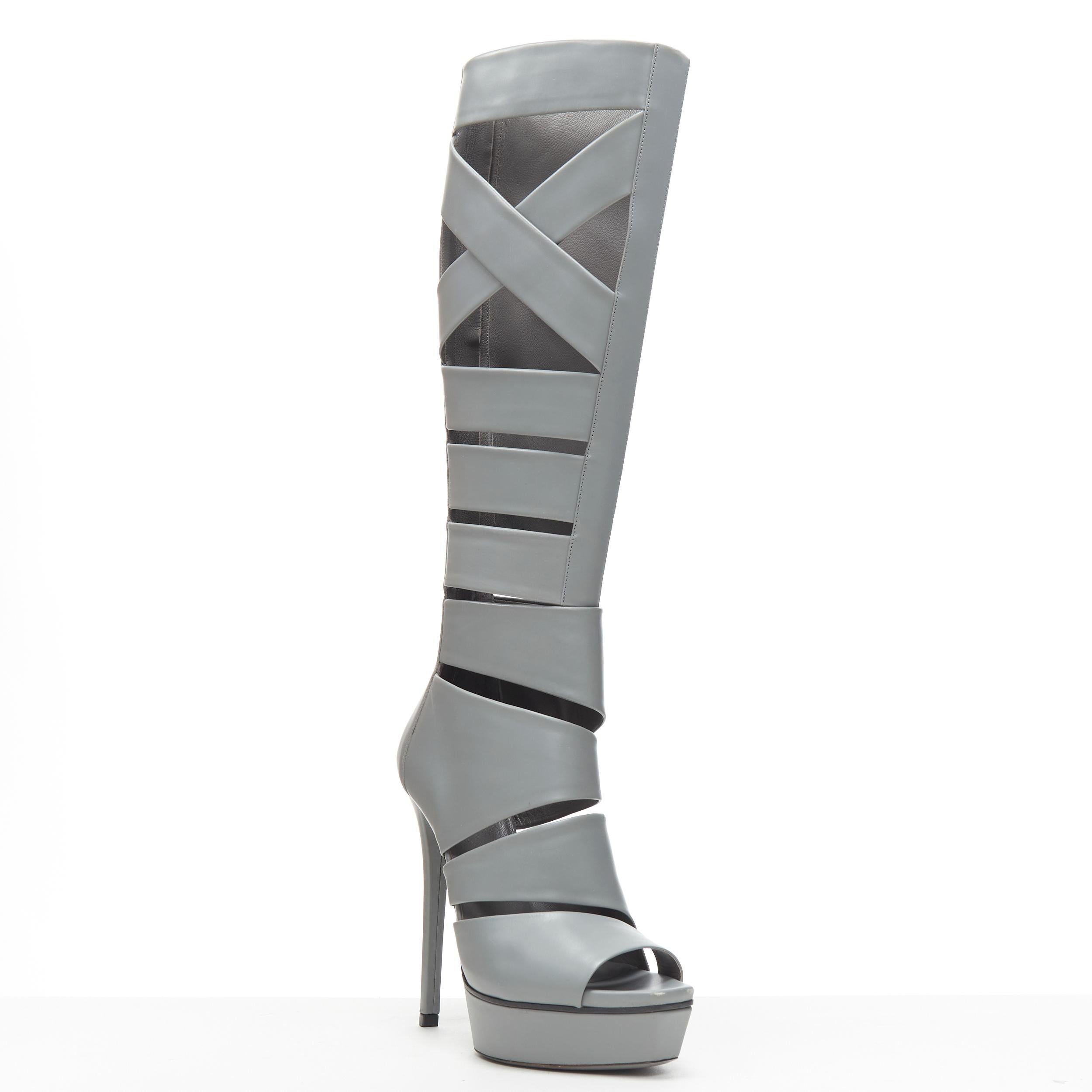 runway GUCCI Runway Helena grey cut out strappy gladiator platform boot EU37 
Reference: GIYG/A00119 
Brand: Gucci 
Material: Leather 
Color: Grey 
Pattern: Solid 
Closure: Zip 
Extra Detail: Cut out gladiator boots. Open toe. Platform sole. 
Made