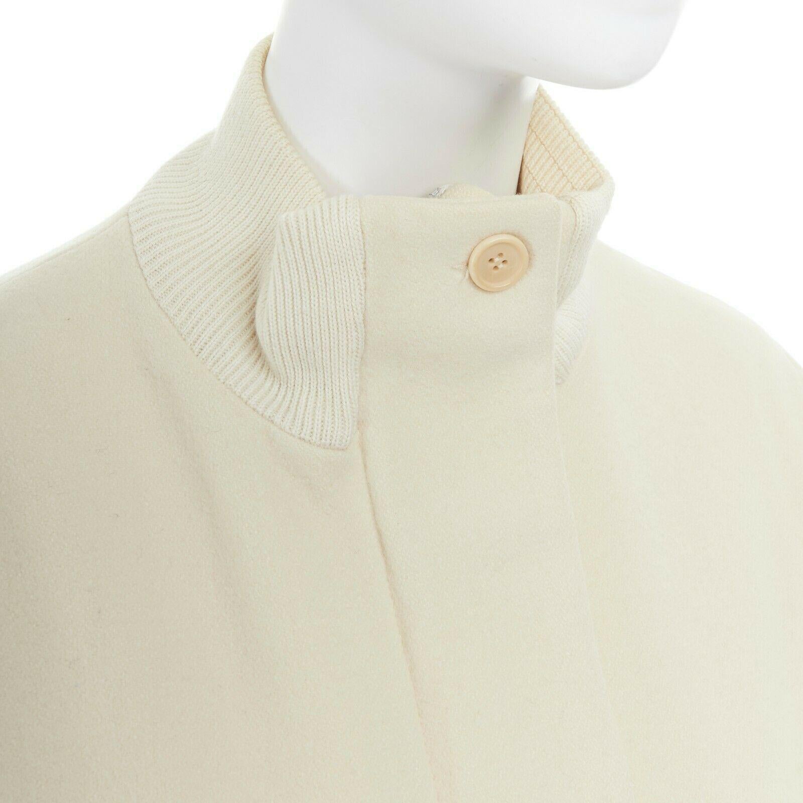 runway HELMUT LANG Vintage AW97 cream bomber collar wool coat jacket IT40 US2 S
HELMUT LANG
FROM THE 1998 COLLECTION
Wool, polyamide, cotton, polyester, acetate, viscose. Cream wool outer. 
Long coat. Ribbed stretch bomber collar. 
Zip front and