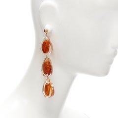 runway JACQUEMUS Les Amandes clear acrylic asymmetric almond drop earrings