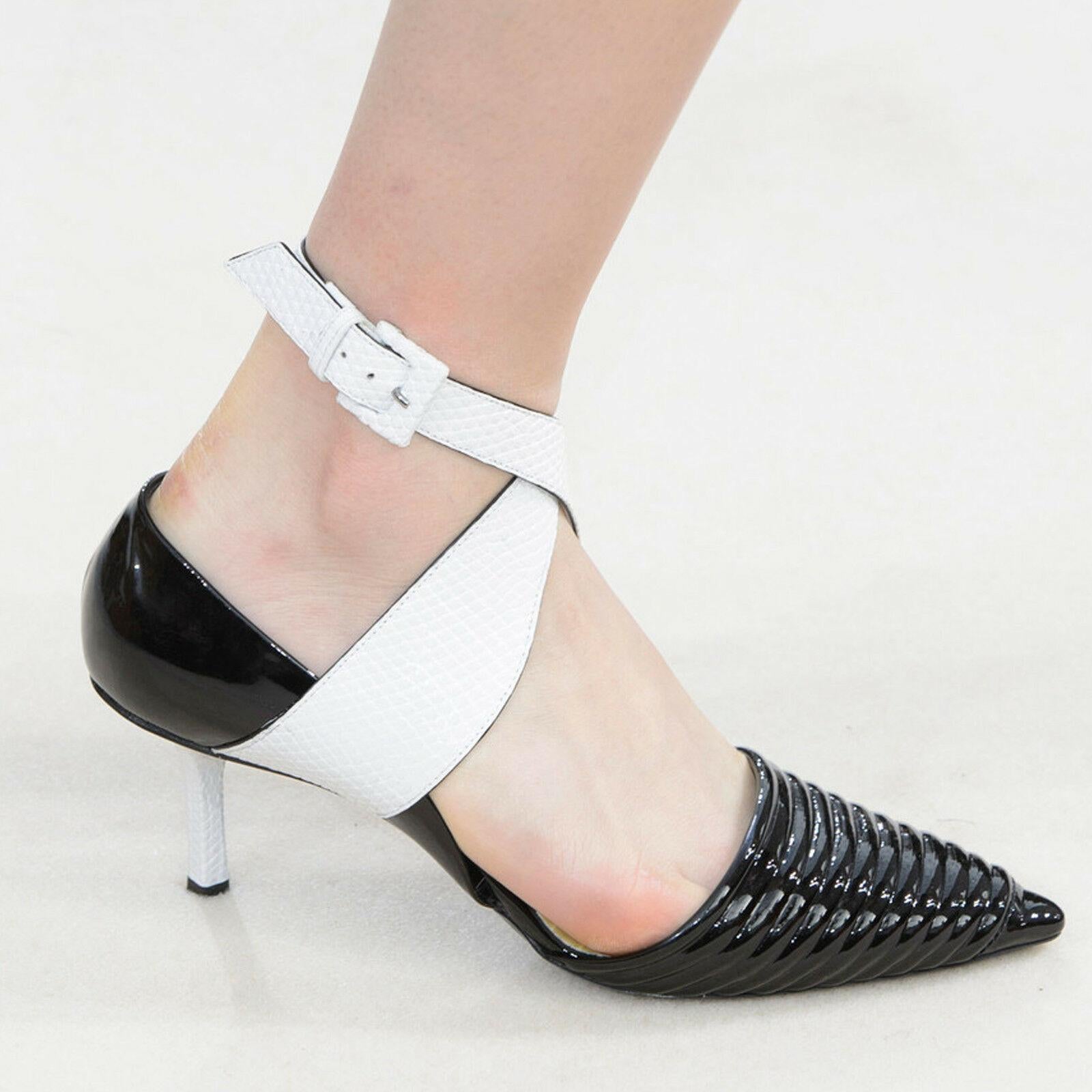 runway LOUIS VUITTON black patent white cross ankle strap dorsay pumps EU38.5 
Reference: TGAS/A02388 
Brand: Louis Vuitton 
Collection: Fall Winter 2015 Runway 
Material: Leather 
Color: Black 
Pattern: Solid 
Closure: Ankle Strap 
Extra Detail:
