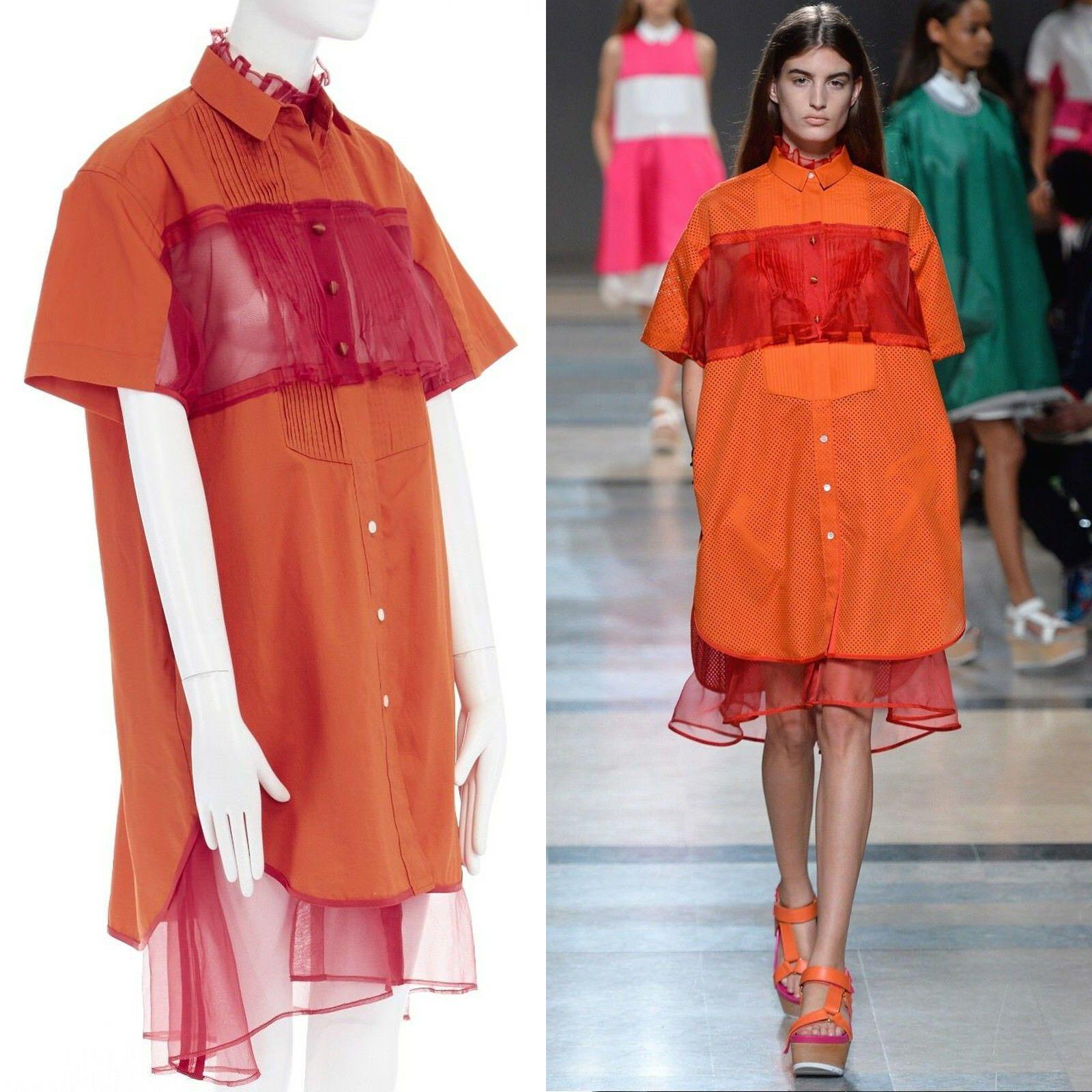 runway SACAI SS14 orange polyester panel pleated collar cotton shirt dress JP1 S
SACAI
FROM THE SPRING SUMMER 2014 RUNWAY
Cotton, silk, polyester. Spread collar. 
Pleated bib front. Red polyester panel block at chest.
Fabric covered buttons. Rounded