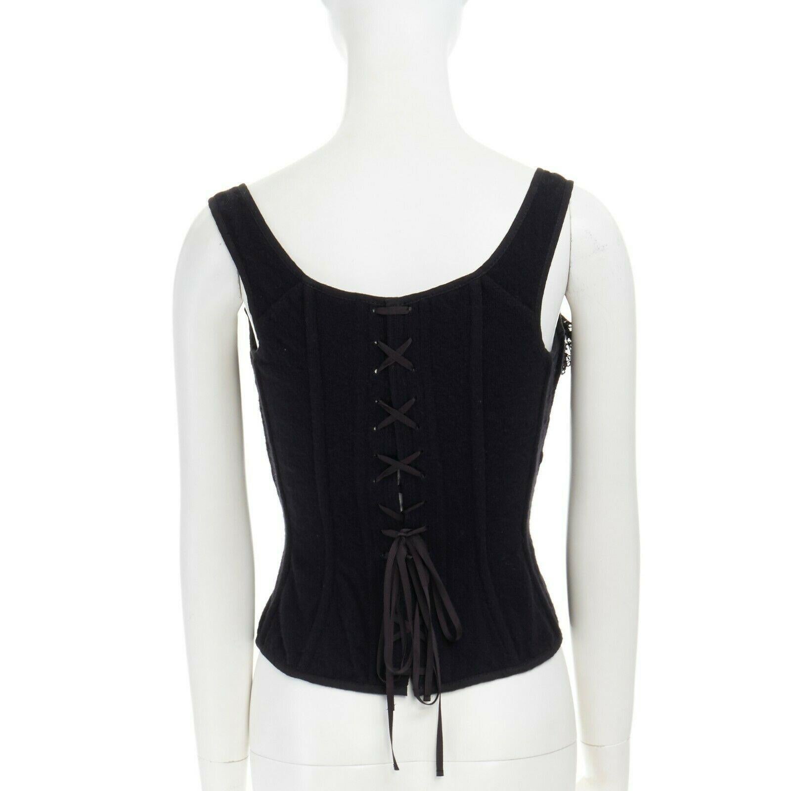 runway TAO COMME DES GARCONS AW2005 black lace ruffle bust laced corset top S
TAO BY COMME DES GARCONS
FROM THE FALL WINTER 2005 COLLECTION
PART OF THE PERMANENT COLLECTION AT THE MUSEUM AT FIT
Wool, nylon, rayon. Black wool. Corset top. 
Floral