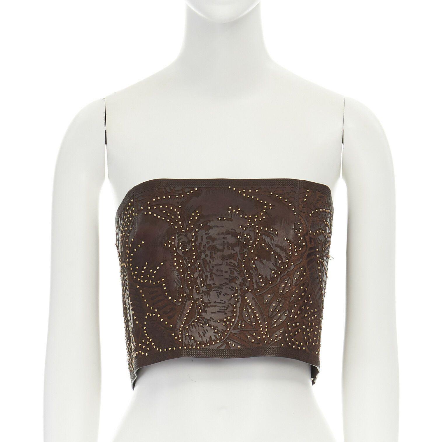 runway VALENTINO SS16 ethnic brown laser cut leather gold studded corset top S
VALENTINO
FROM THE SPRING SUMMER 2016 RUNWAY
Ethnic leaf pattern. Brown etched leather. 
Faux python textured etching around edges. Bust dart for fit. 
Gold-tone micro