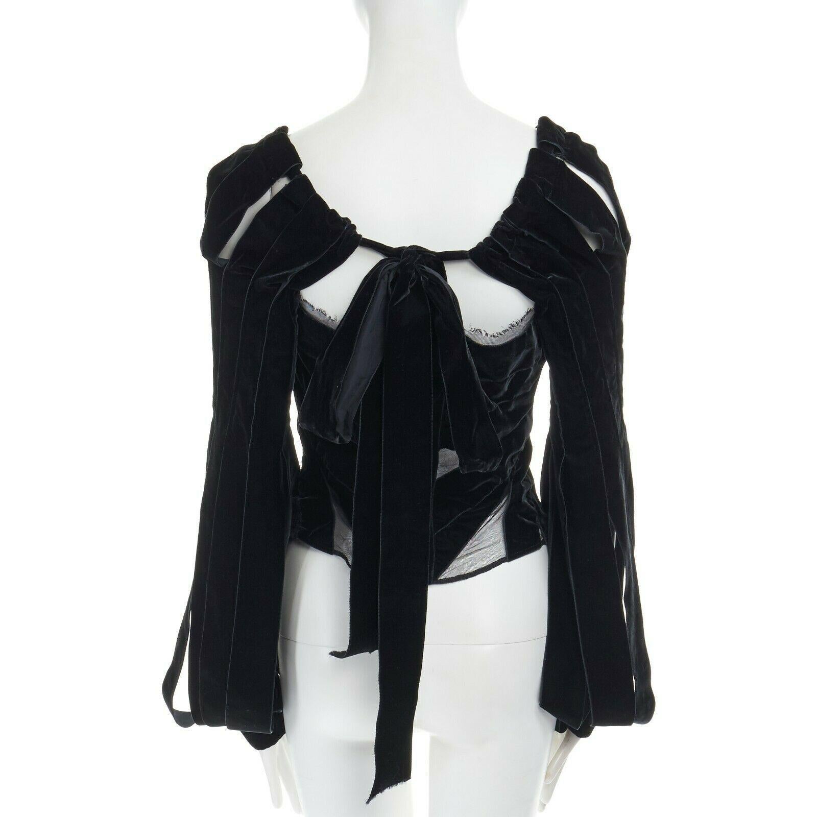 runway YVES SAINT LAURENT TOM FORD AW02 black velvet ribbon trim corset top FR40
YVES SAINT LAURENT BY TOM FORD
FROM THE FALL WINTER 2014 RUNWAY100% SILK. CONSTRUCTED WITH BLACK VELVET RIBBONS. 
CORSET FIT AT WAIST. LINED IN NET MESH. HOOK AND EYE