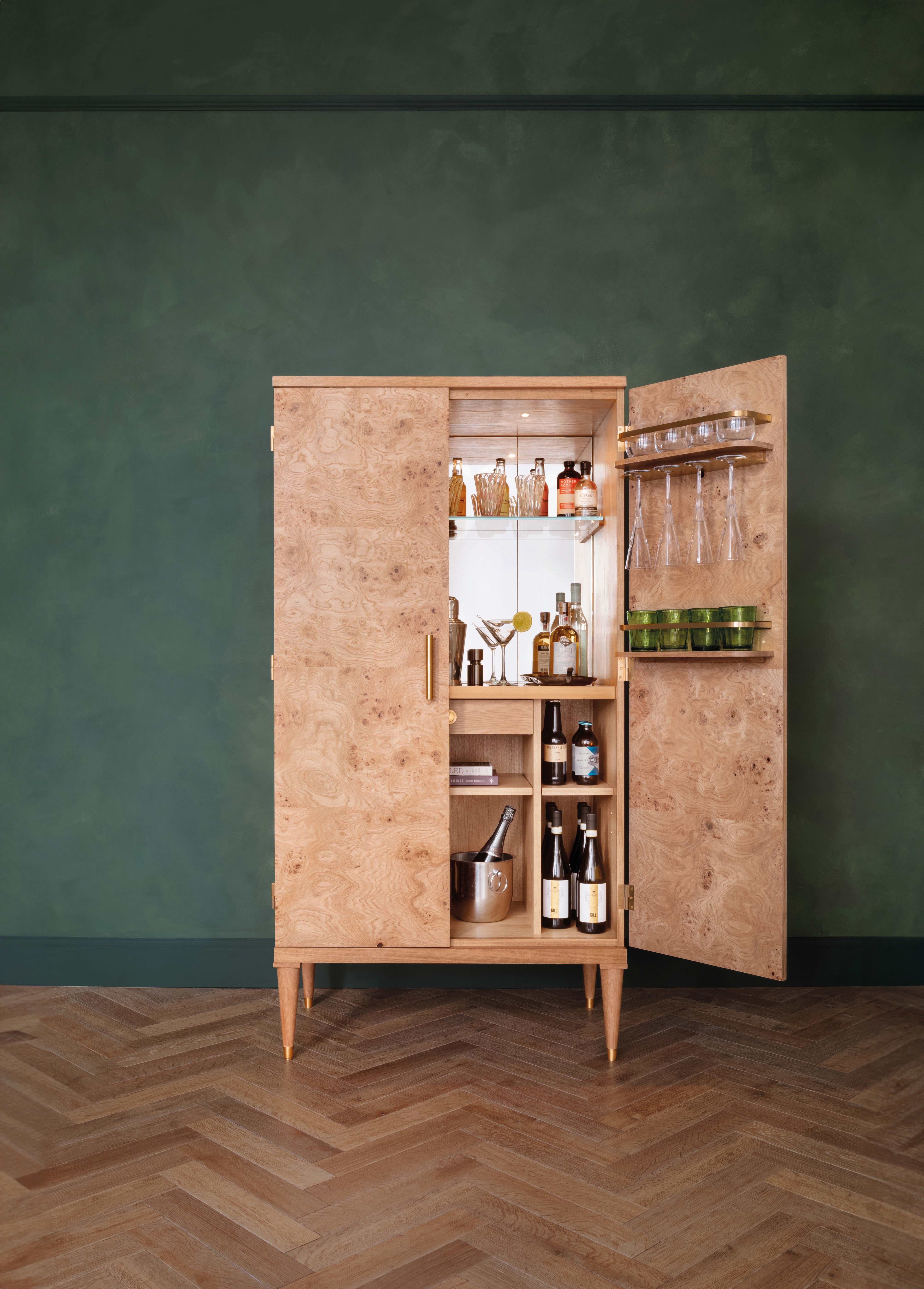 Inspired by nature, our beautiful Burr Oak cocktail cabinet with natural oak carcase, burr oak doors and side panels, antiqued brass trim, mirror glass back panel and a black glass countertop.

Available to view in our London Showroom.