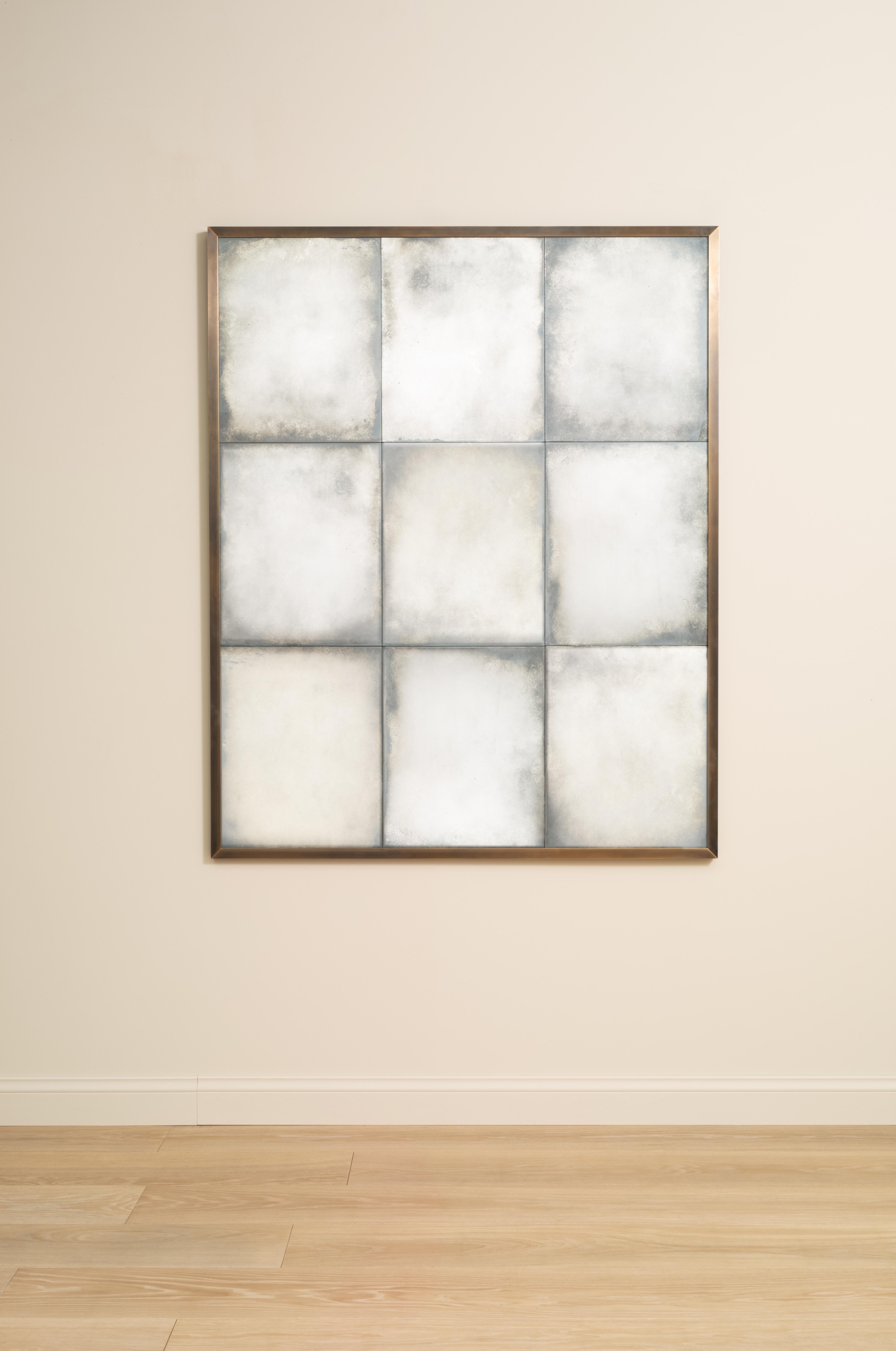 The Braque Overmantel Mirror features a patinated brass angle frame with nine lightly antiqued mirror glass panels.

Handcrafted in our Shropshire Workshops, each mirror is made with hidden split batten wall fixings.