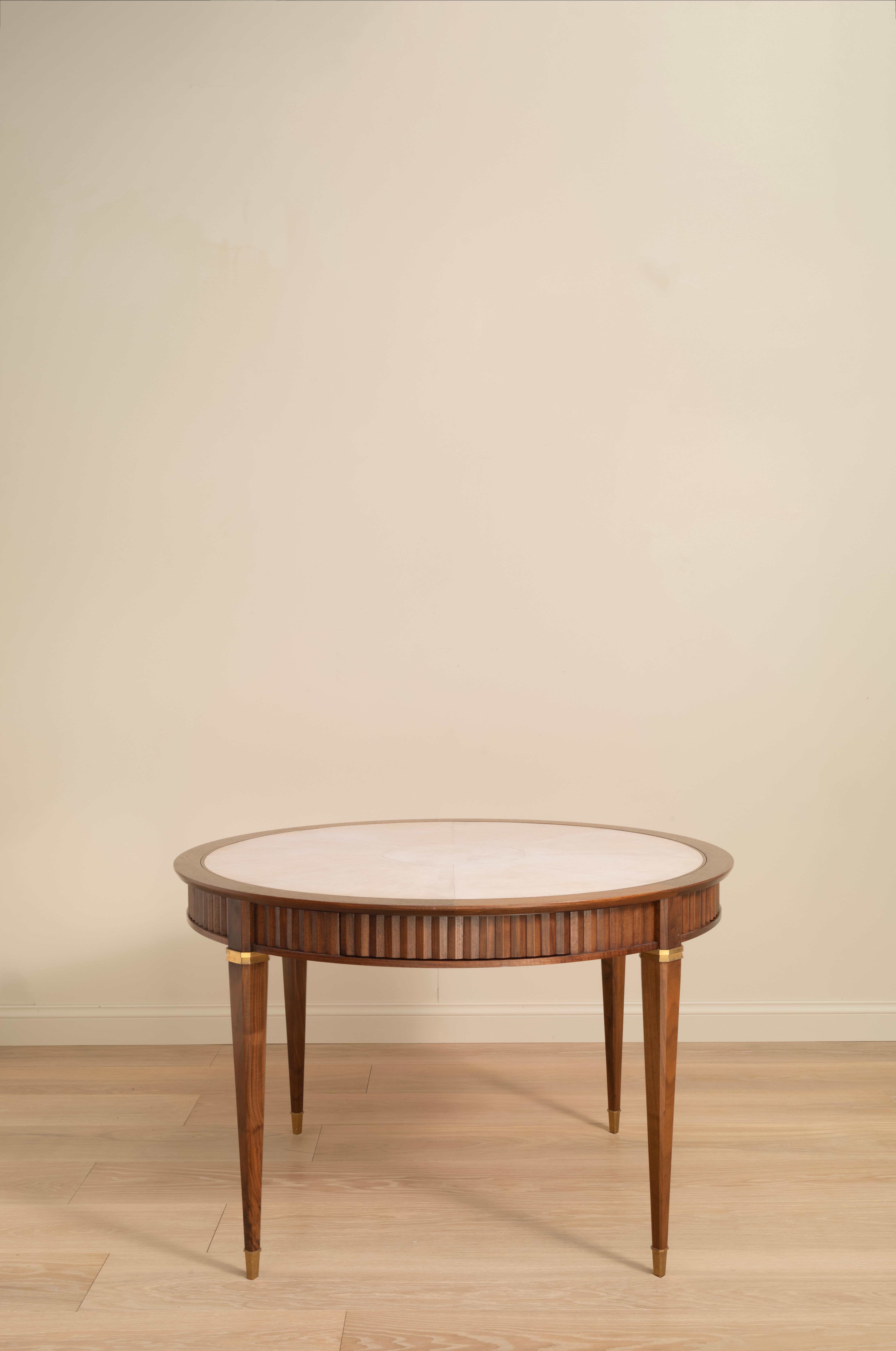 An exceptional games table, traditionally constructed from walnut. The natural vellum top features an alcantara surface on the reverse side for playing cards.

The compendium includes a beautiful marquetry backgammon board with stones, chessmen,