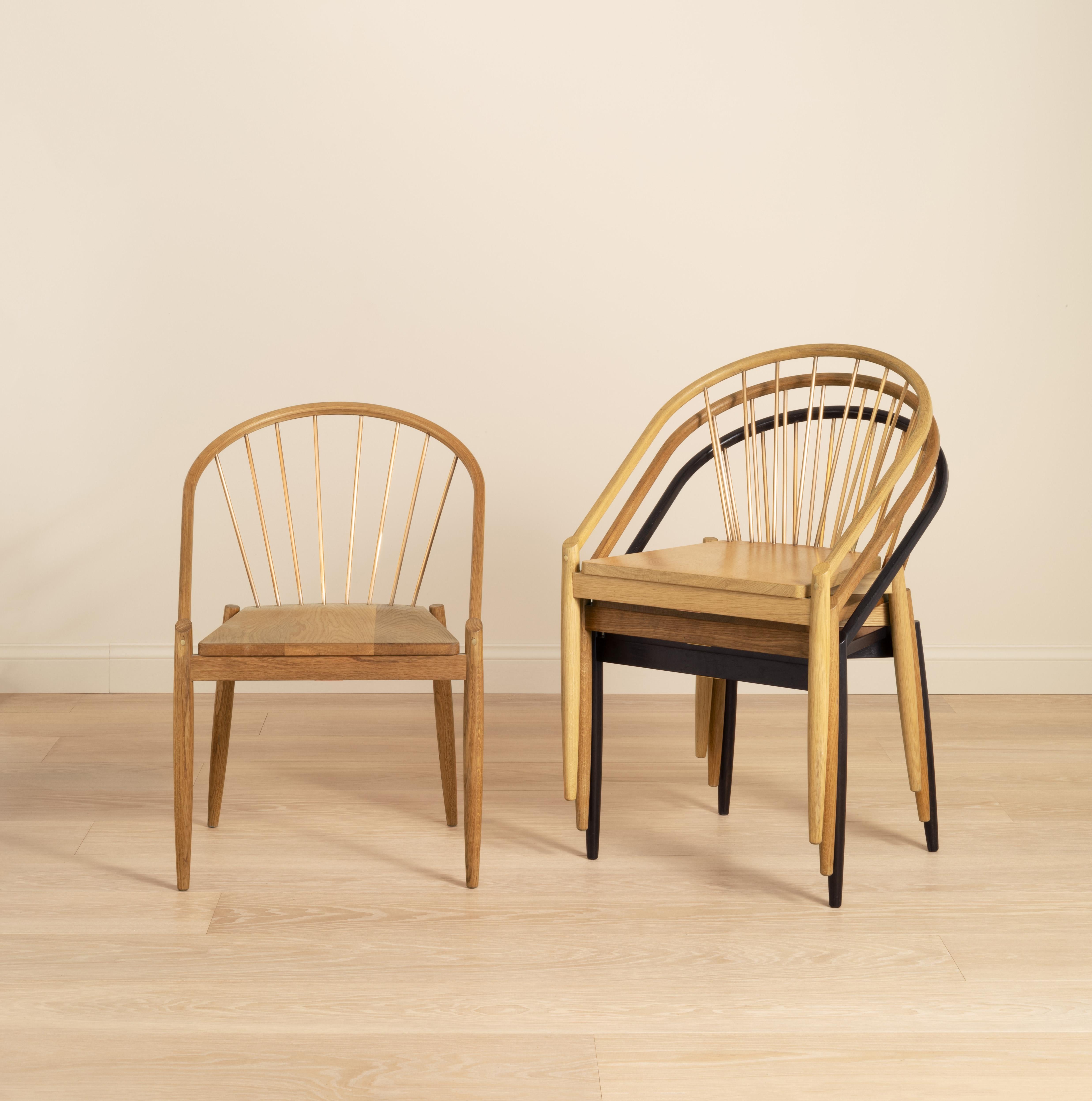An elegant stacking chair inspired by classic Danish design, each chair is handcrafted in our Shropshire workshop, made in solid oak with solid brass rods and available in four different finishes: Light, Mid, Dark and Ebonised.
​
Available to view