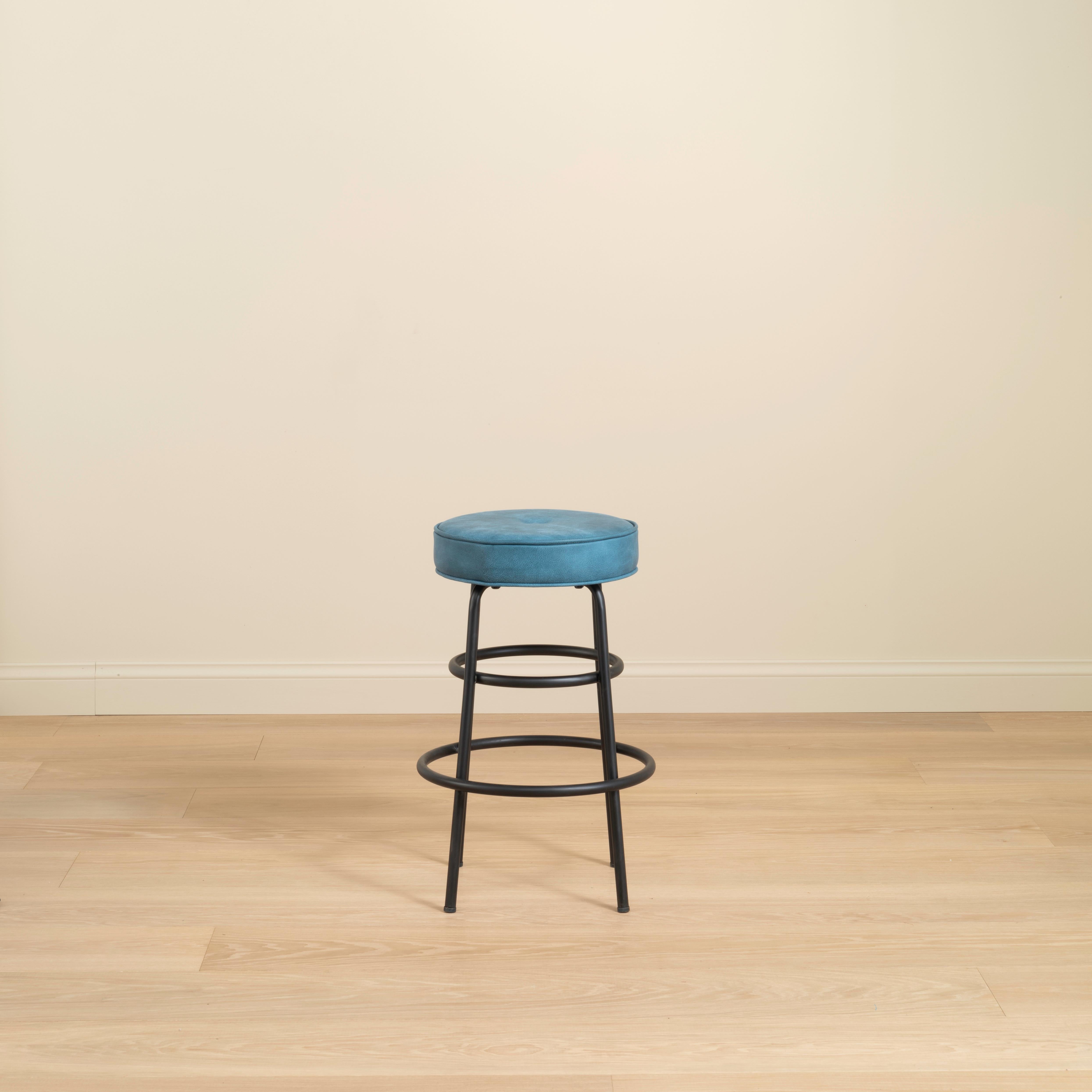 The Hoop Bar Stool features a deep and comfortable fitted cushion, upholstered in-house using the client’s choice of leather or fabric. The circular lines of the cushion are reflected in the fitted rings that hug the steel chair legs.

Upholstered