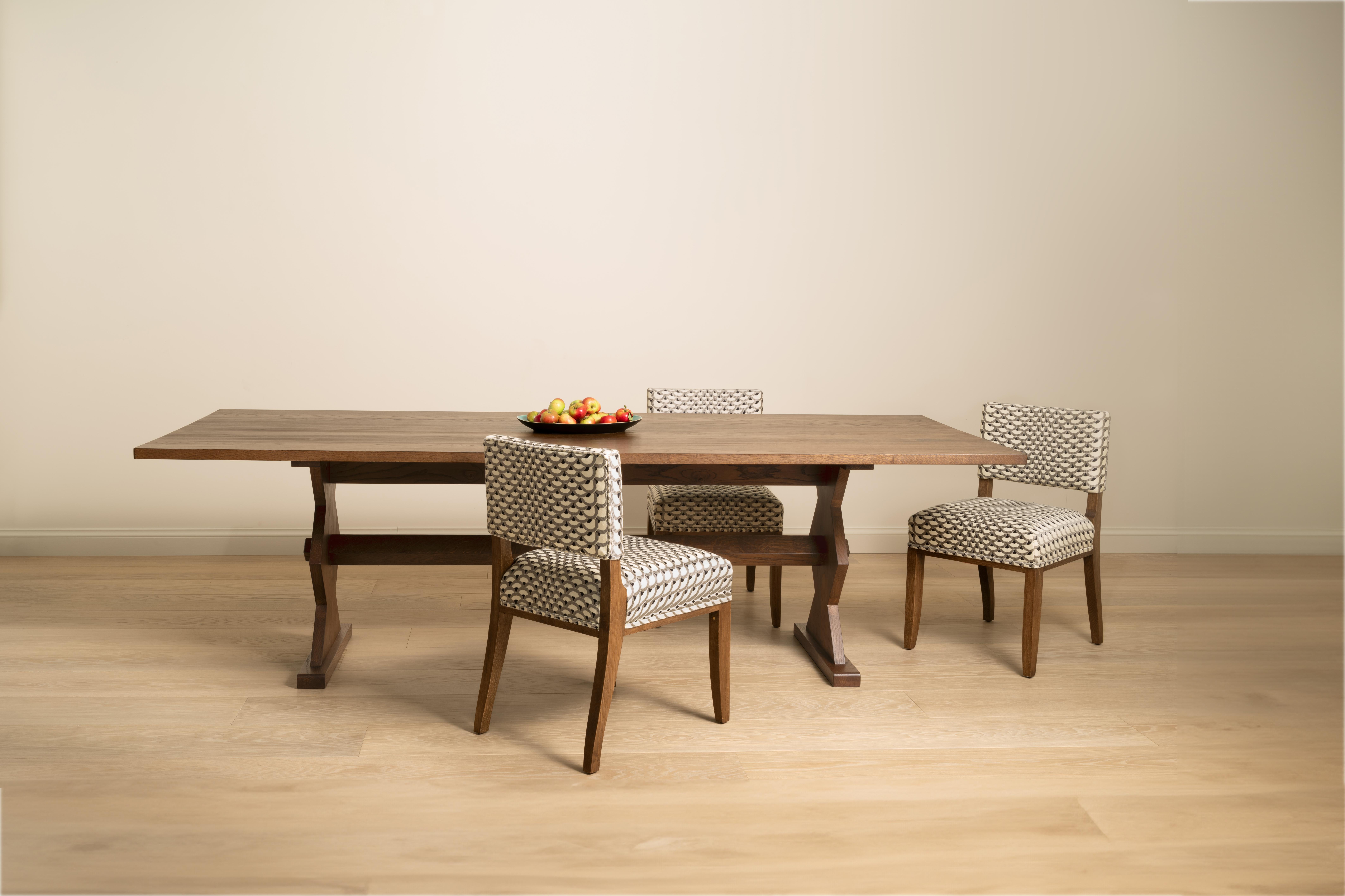 A contemporary dining table with geometrically shaped legs inspired by the designer Marcel Coard. Traditionally constructed in solid oak and available in a Light, Mid, Dark and Ebonised finish.
​
Available to view in our London showroom.