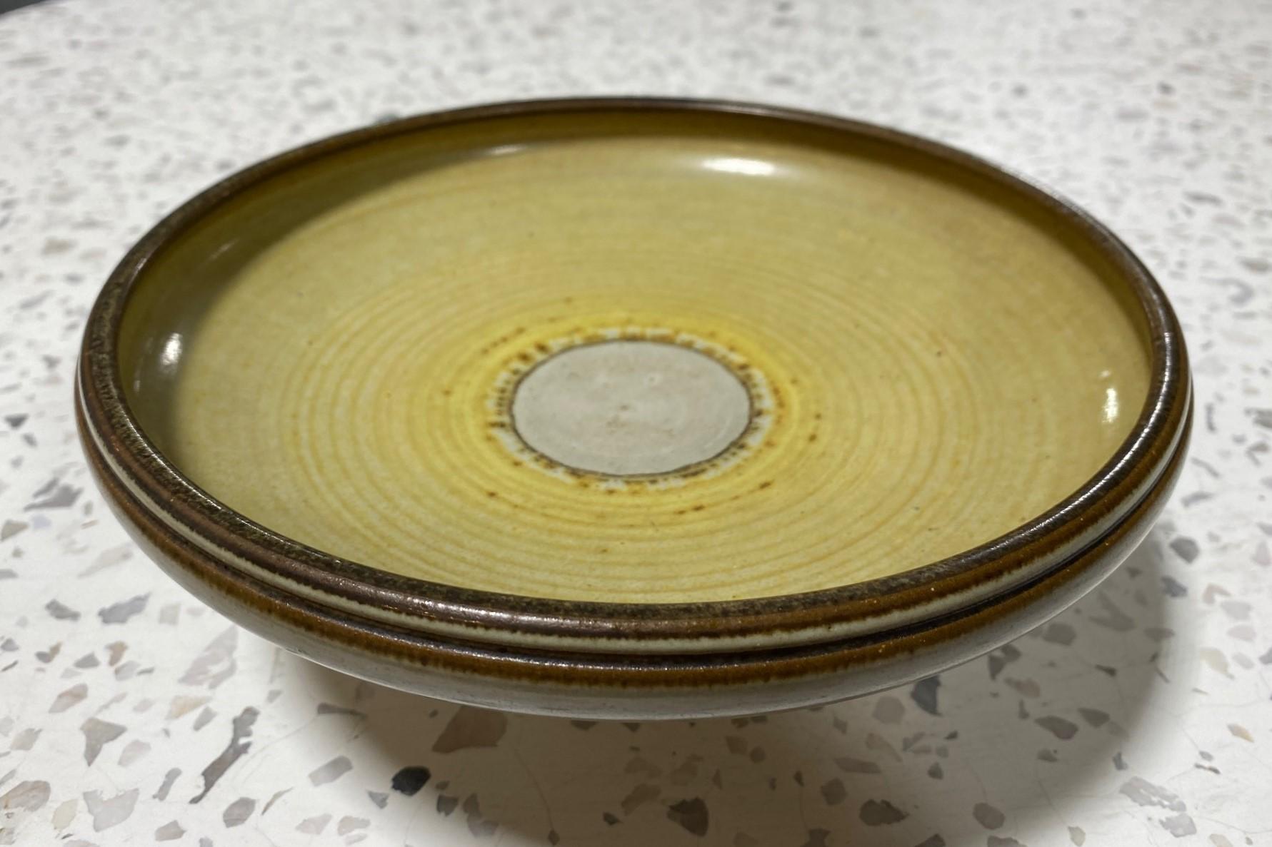 A gorgeously crafted, beautifully yellow glazed, Mid-Century Modern pedestal bowl by California master ceramist Rupert Deese who worked closely with pottery legend Harrison Mcintosh.

Signed with Deese's cipher/ stamp on the base as well as the