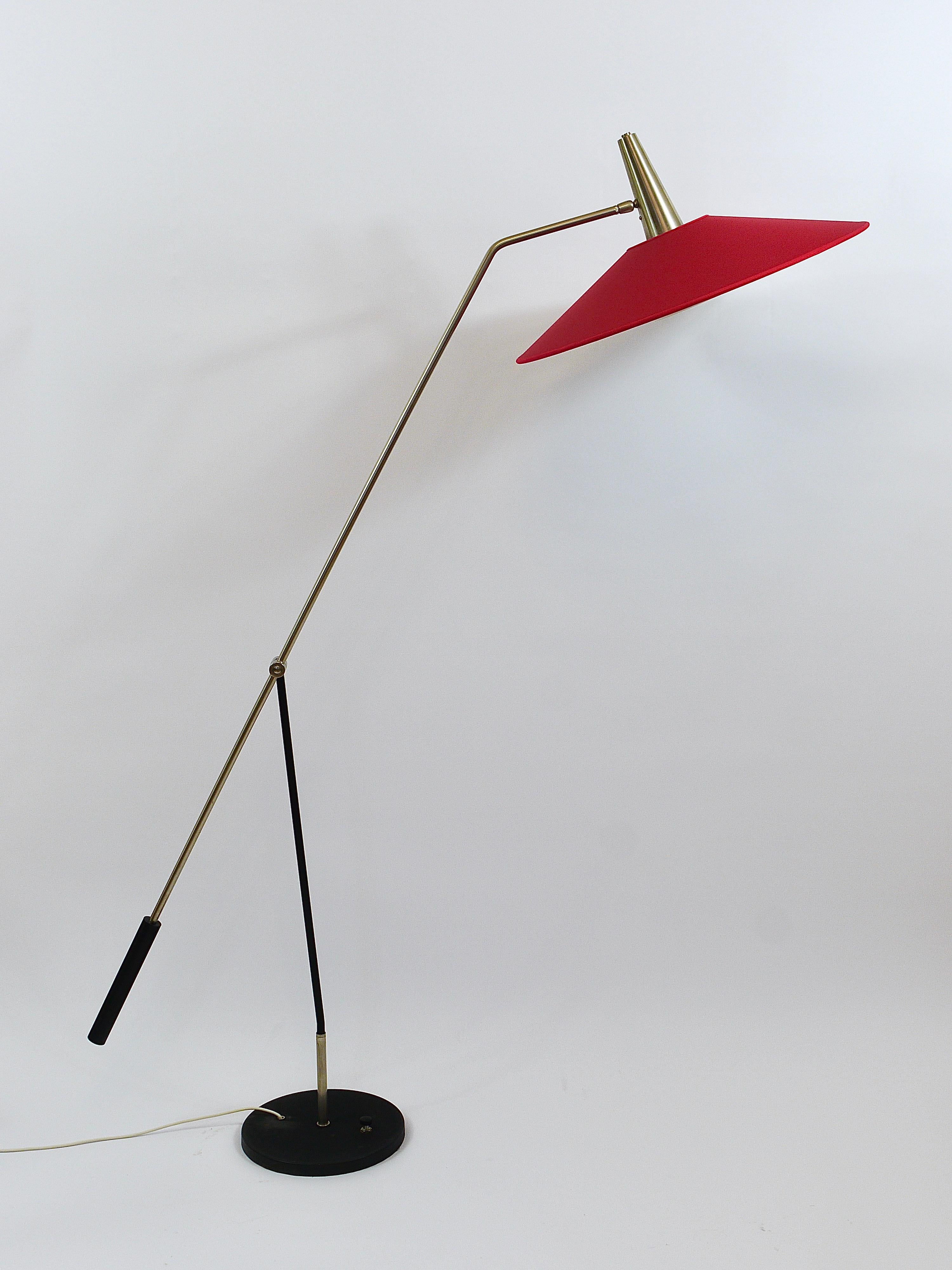 An elegant and beautiful, orientable modernist articulating floorlamp with counterweight from the 1960s, executed by Rupert Nikoll, Austria. Made of brass with a lovely nickel-plated surface and a round black iron swivel base with integrated step