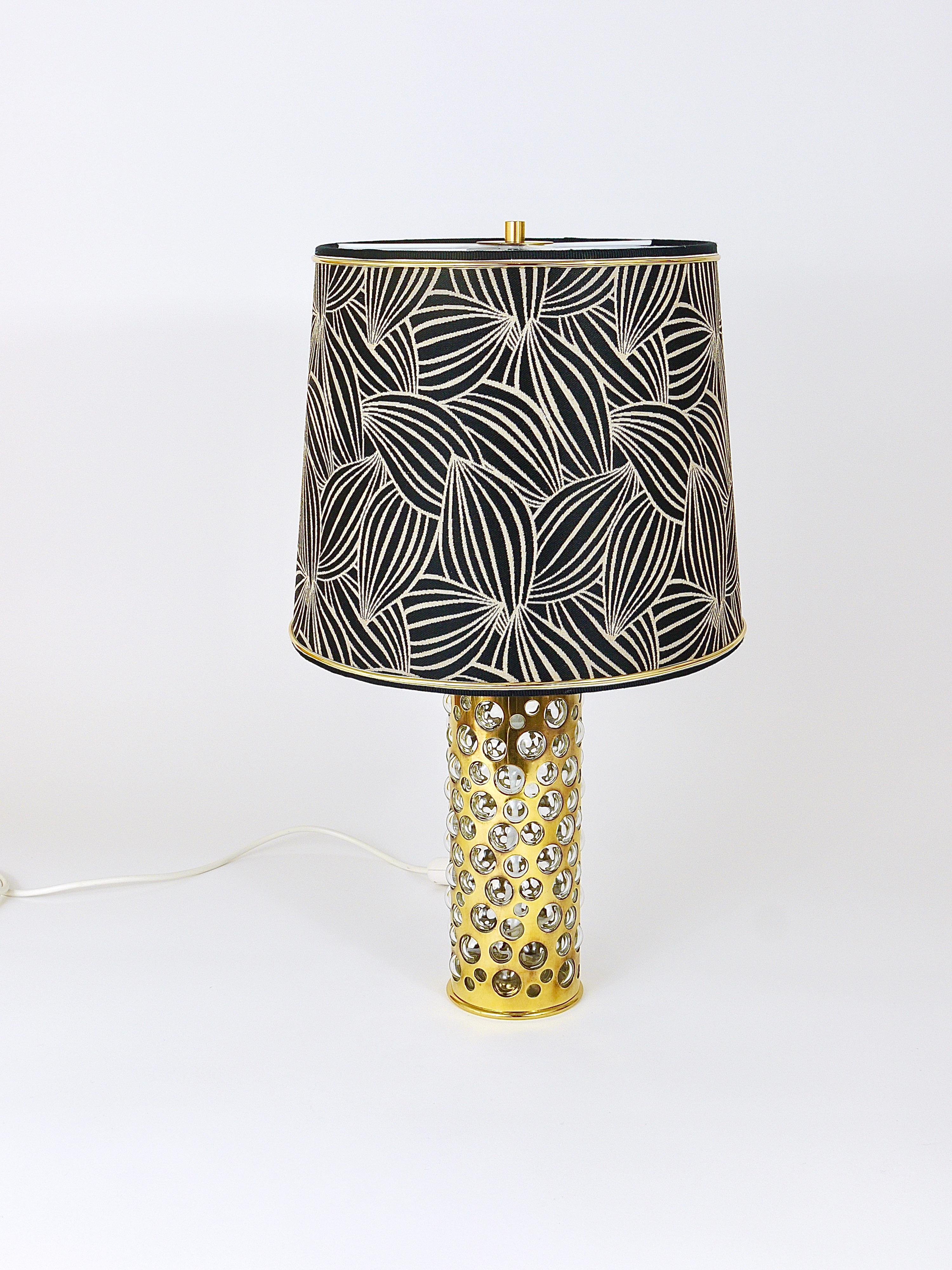 A beautiful modernist table lamp / side lamp from the 1950s, designed and executed by Rupert Nikoll Vienna, Austria. Made of polished brass and mouth blown clear glass with bubbles in various sizes. Comes with a professionally refurbished lampshade,