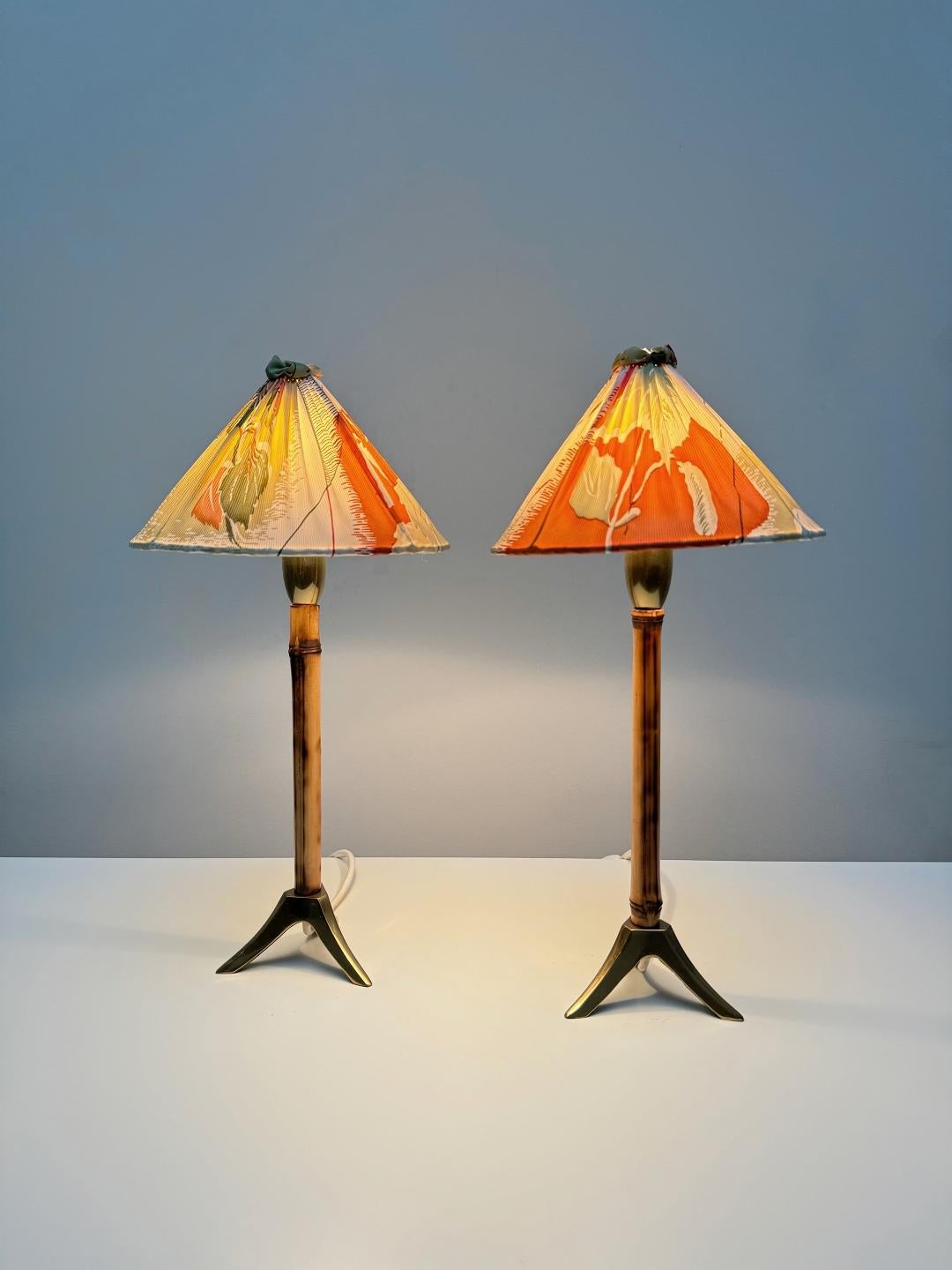Elegant nightstand or table lamps designed and manufactured by Rupert Nikoll in 1950s, Vienna. The lamps feature a solid brass tripod base with typical Nikoll bamboo tube elements. Generally, he was inspired by the Japonism movement. Fully working