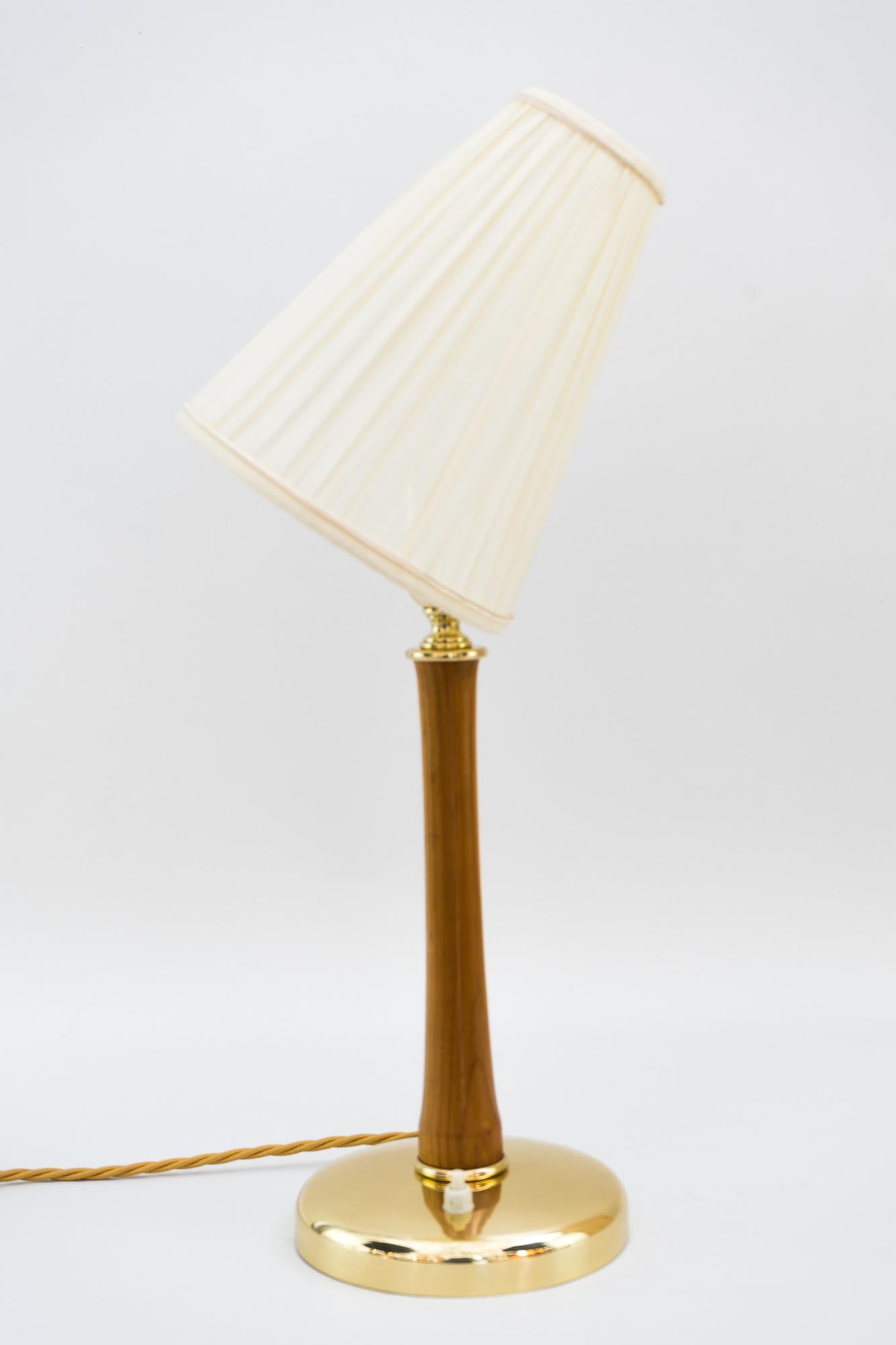 Rupert Nikoll table lamp, Vienna, circa 1950s
Brass parts polished and stove enameled
Nutwood polished
The shade is replaced (New).