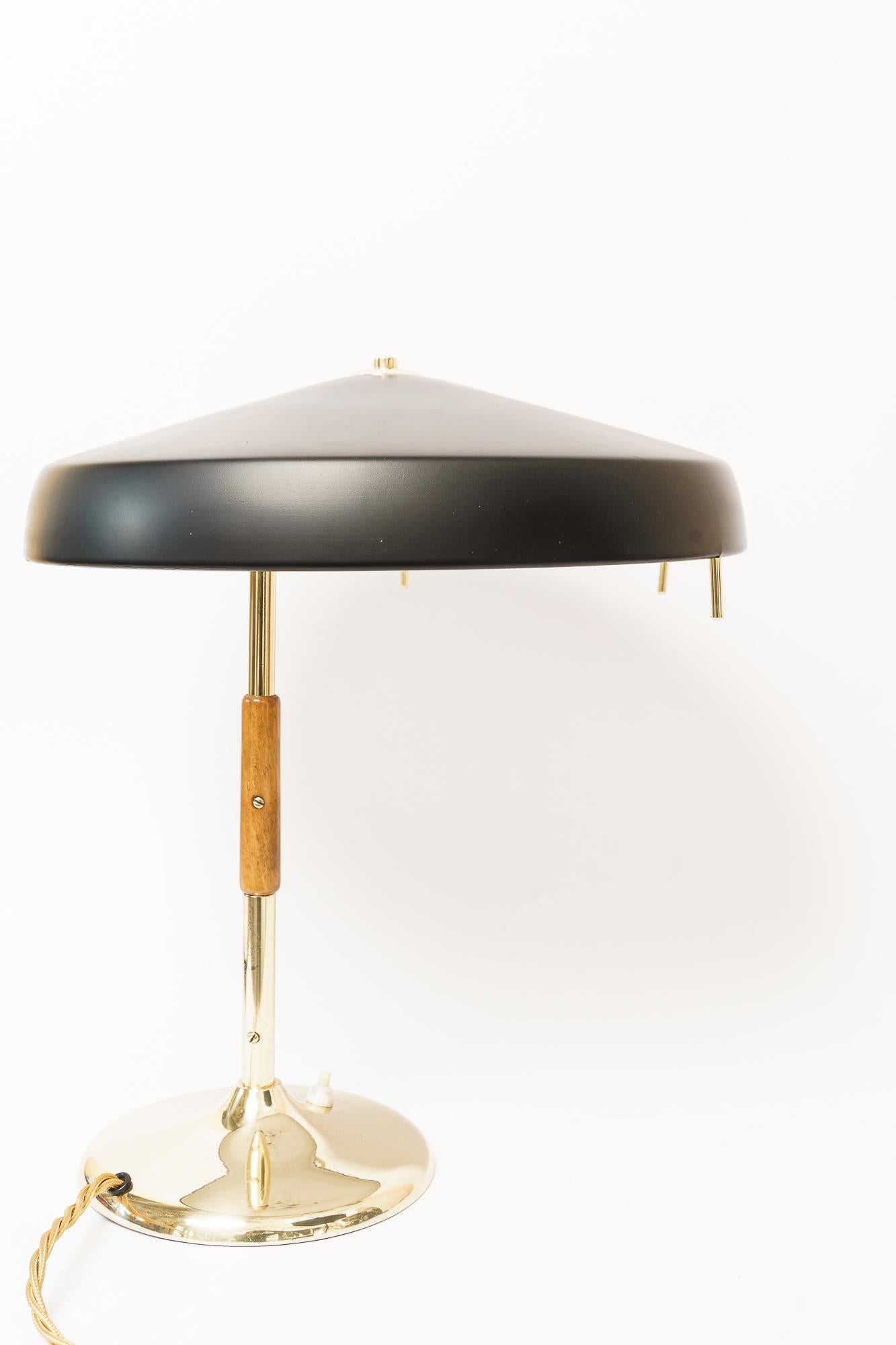 Rupert Nikoll table lamp vienna around 1960s
Brass polished and stove enameled
Wood handle
The shade blackened.