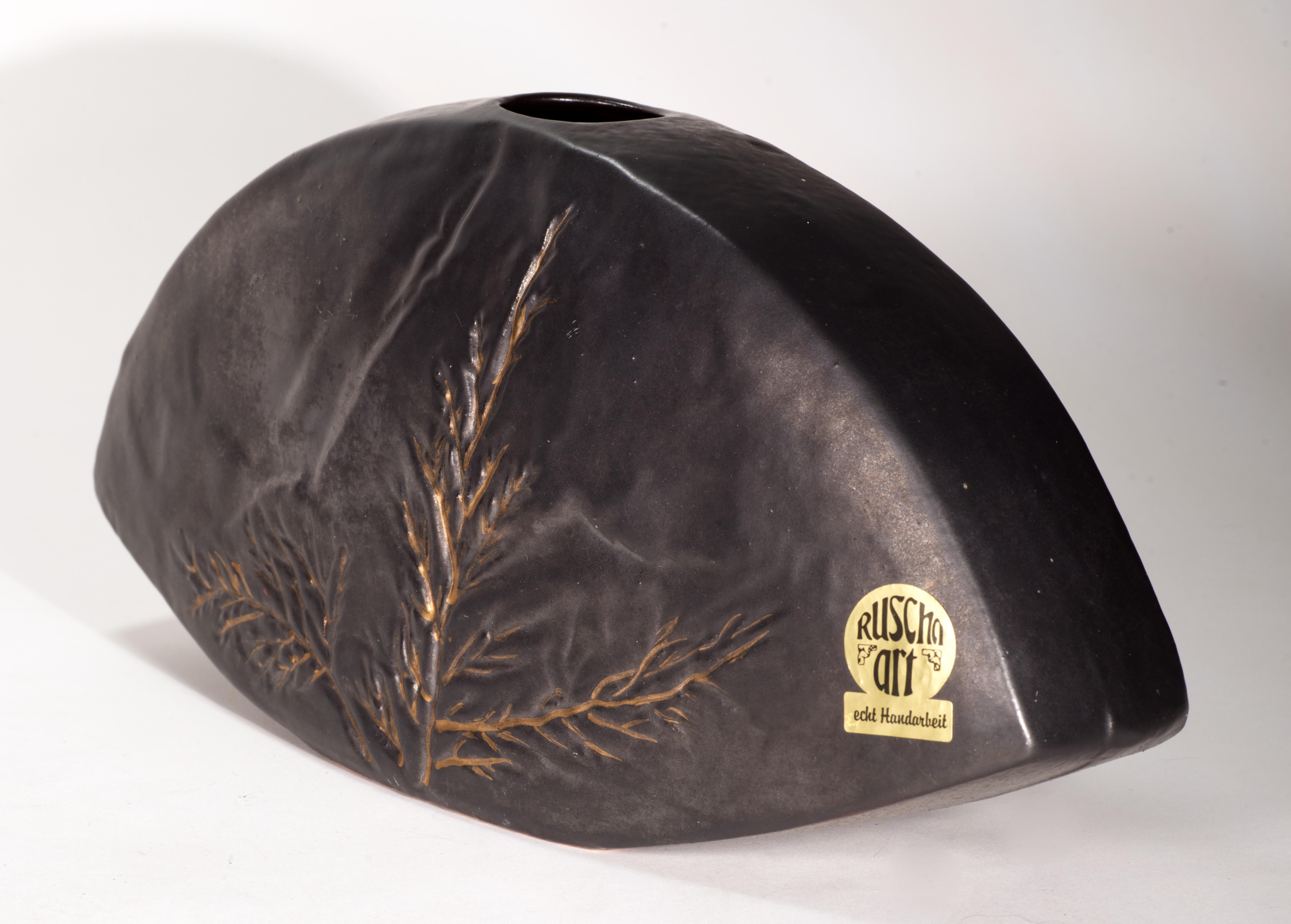  Striking vintage vase features complex espresso brown glaze with sgraffito decor on the front of the vase. Abstract botanical decor follows the unusual demi-lune shape of the piece; the sgraffito is accented with thin, tasteful gold brushstrokes