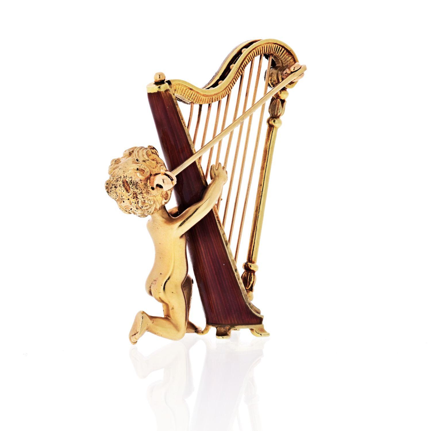 Retro circa 1940s Ruser 14k gold brooch, depicting a Cherub playing harp, decorated with sapphire eyes and approx. 0.20ctw in diamonds. Measures 45mm x 30mm. Irresistible, mischievous, and often a trouble maker. Where Cupid is, love will