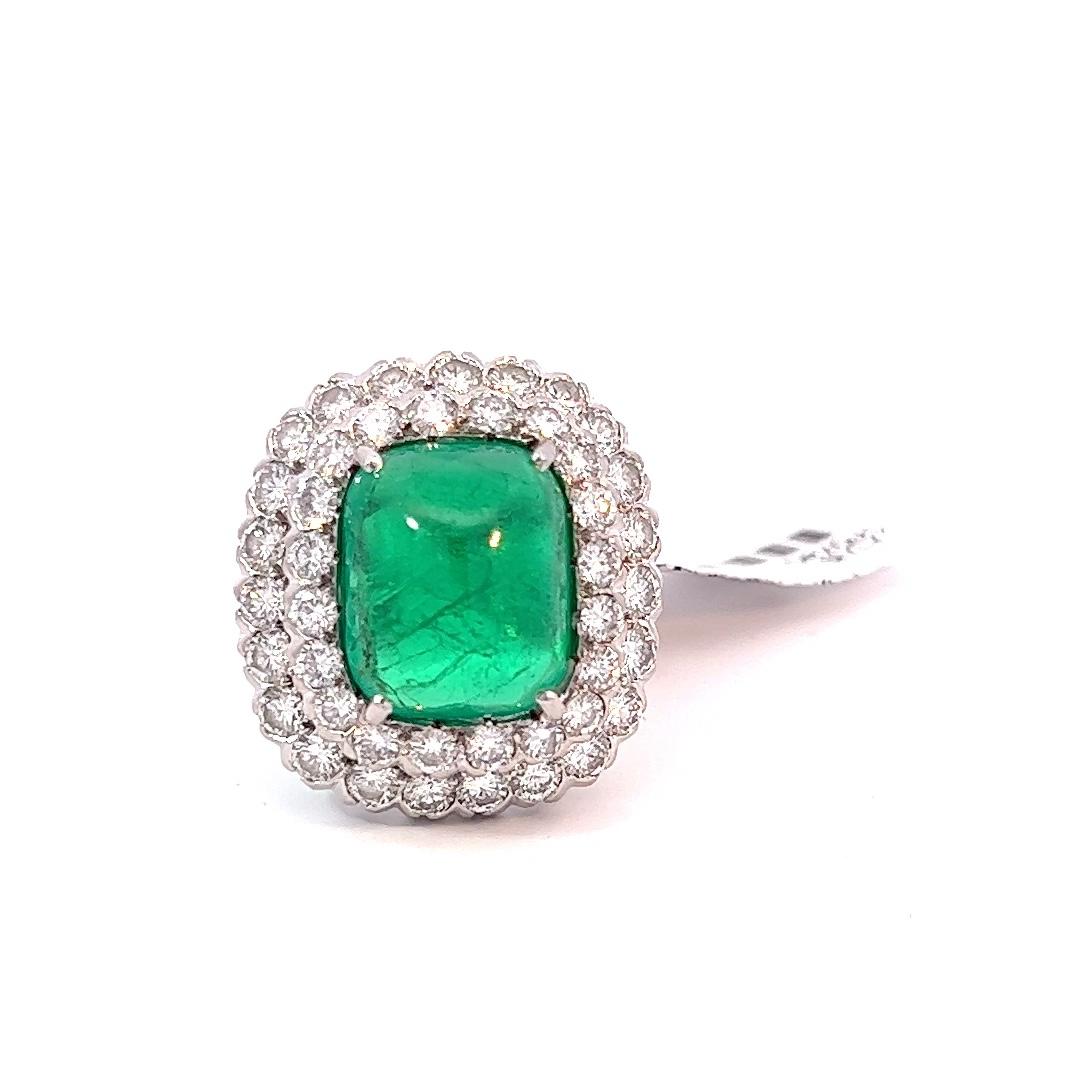 Columbian 7.50 carat Sugarloaf Cabochon Emerald and diamond ring signed by Ruser, AGL certified. The emerald has Insignificant to Minor clarity enhancement, which is very rare.
Embracing the emerald are 43 round brilliant cut diamonds, F-G color,