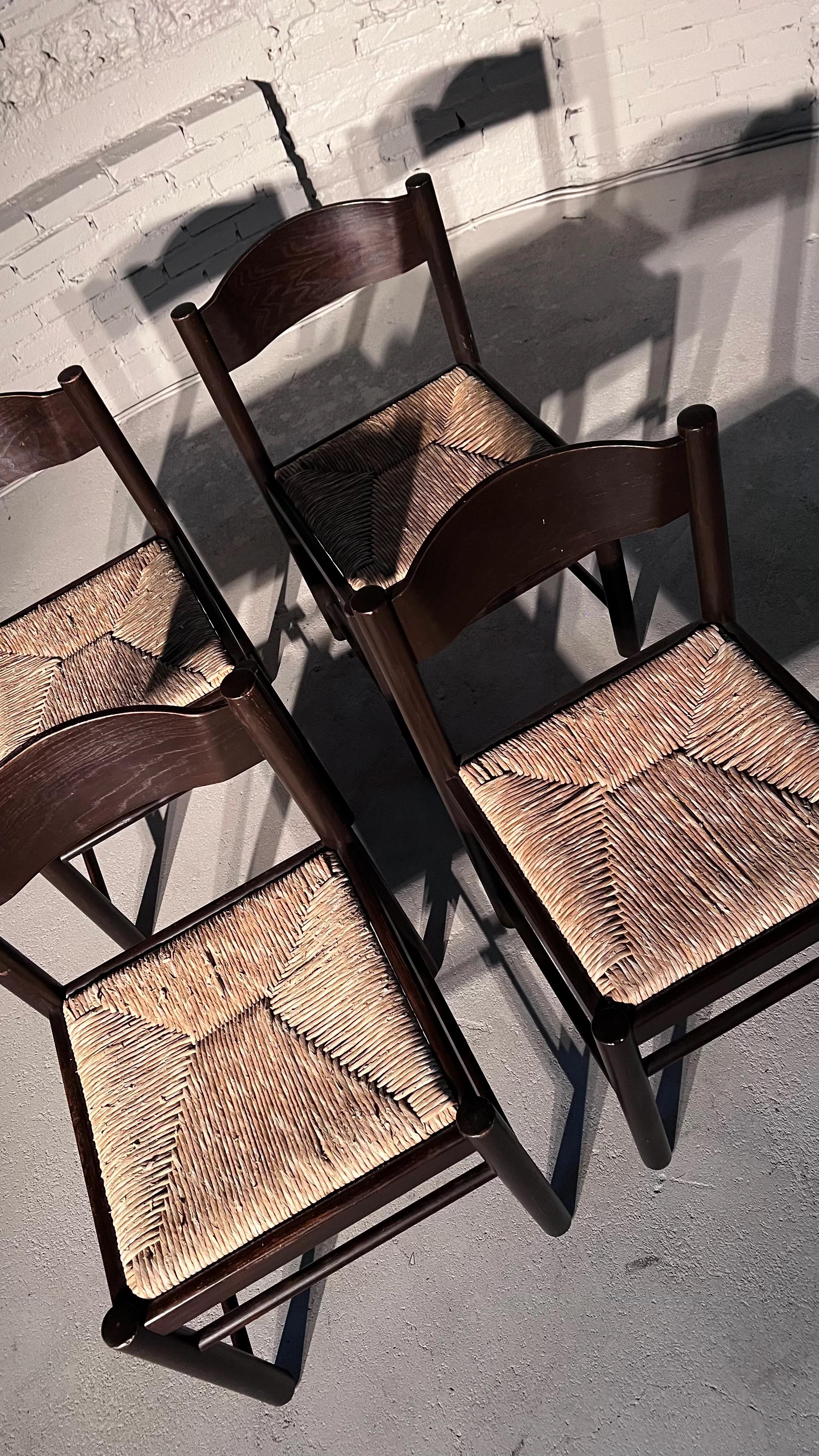 Lovely set of 4 rush dining chairs in the style of Vico Magistretti, made in Italy in the 80's. The chocolate brown lacquer and rush have normal traces of use.