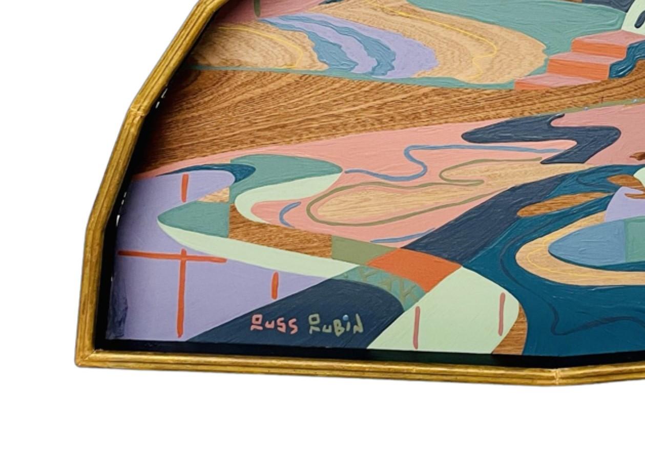 Contemporary colorful abstract landscape painting by New Jersey based artist Russ Rubin. The work features an otherworldly landscape winding in muted desert hues hung by the artist in a vintage gilt decorative frame that beckons the viewer into