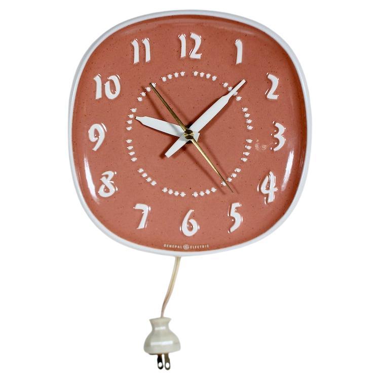 Russel Wright Harkerware Ceramic and General Electric Hanging Wall Clock.  Featuring a rounded square and concave Coral Ceramic Front with glazed Off White Ceramic surround and back. Original Off White 8
