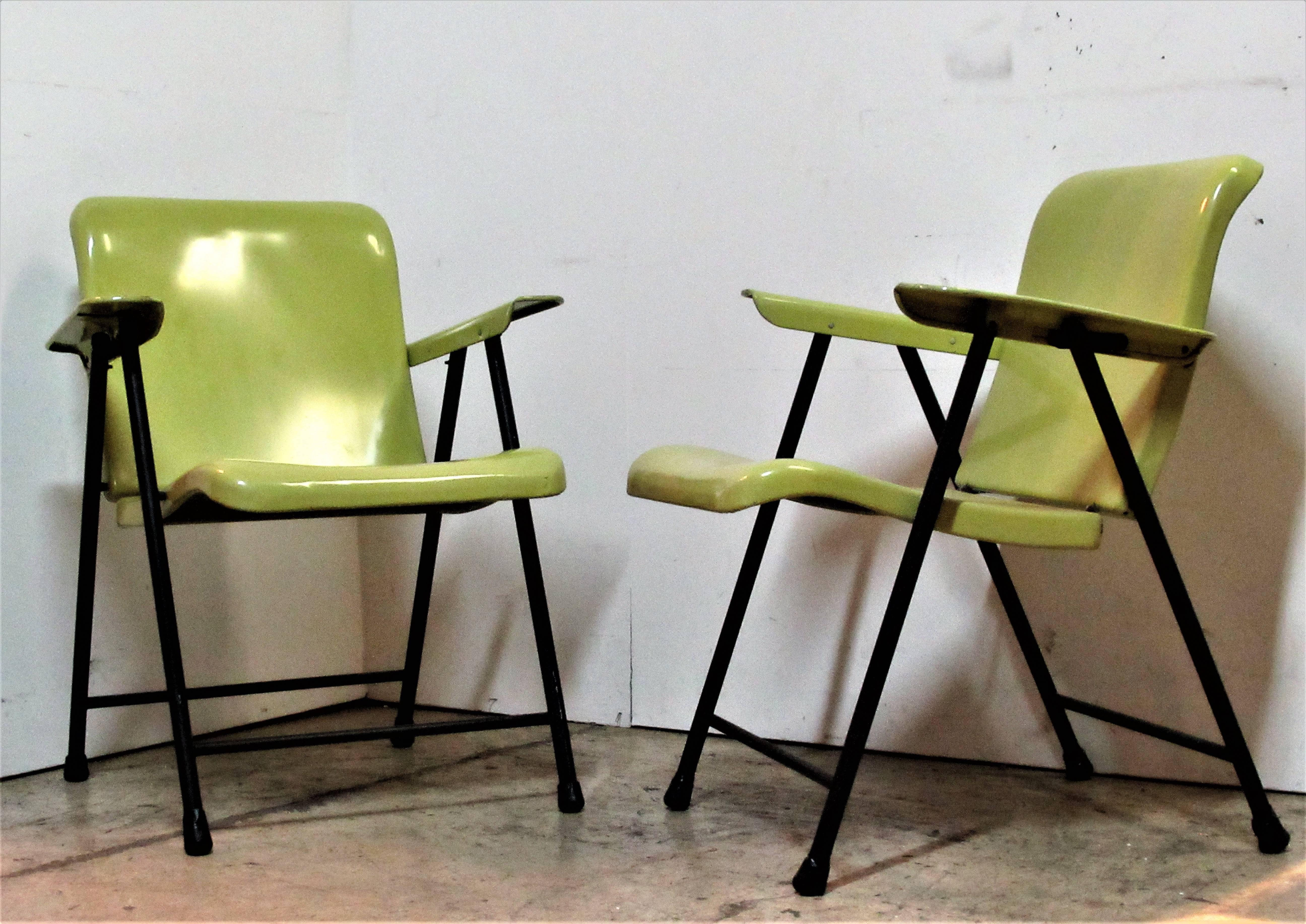 A pair of mid-20th century steel folding armchairs by Russel Wright for Samsonite in 100% all original glowing chartreuse and black factory enamel painted surface. Hard to find in this great condition.